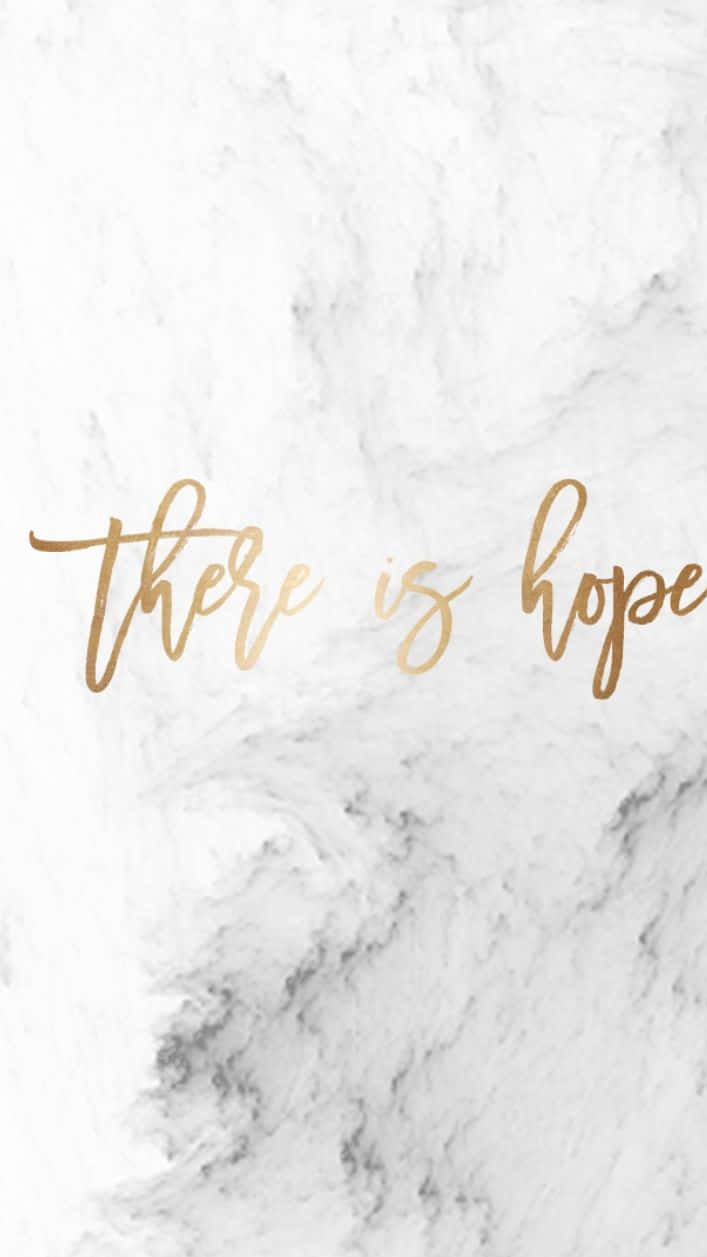 Marble Quotes 桌布 壁紙 — 優雅的金色草書文字「there is hope」覆蓋在帶有細微灰色紋理的潔白大理石背景上。
