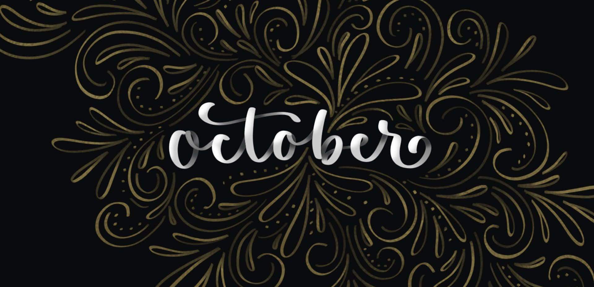October 桌布 壁紙 — 優雅的銀色字體拼寫出october，周圍環繞著精緻的金色鏤花，背景為深黑色。