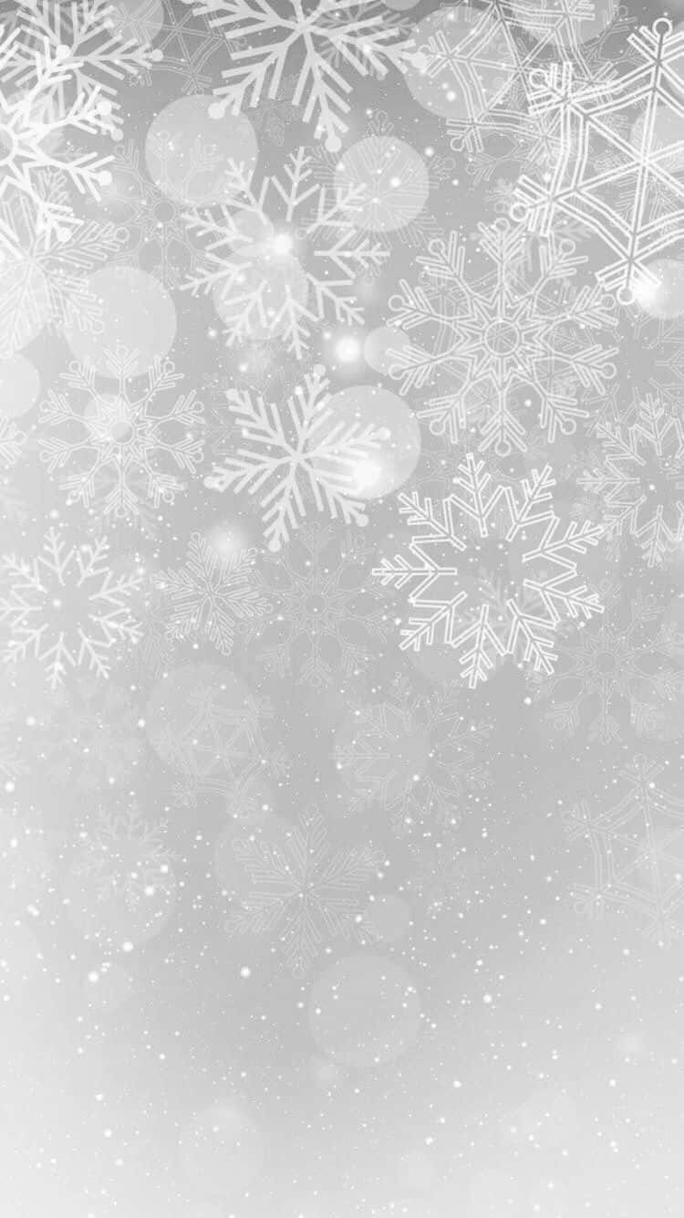 聖誕節 桌布 壁紙 — 優雅的銀色雪花在柔和的漸變背景和散景燈光中輕輕飄落。