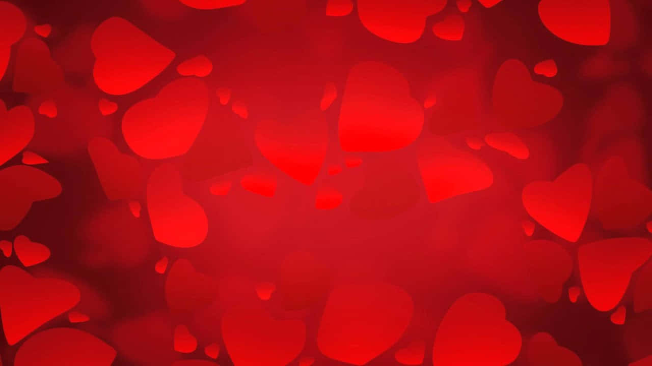 愛心 桌布 壁紙 — 充滿柔和模糊心形圖案的鮮豔紅色背景，營造出浪漫夢幻的氛圍。