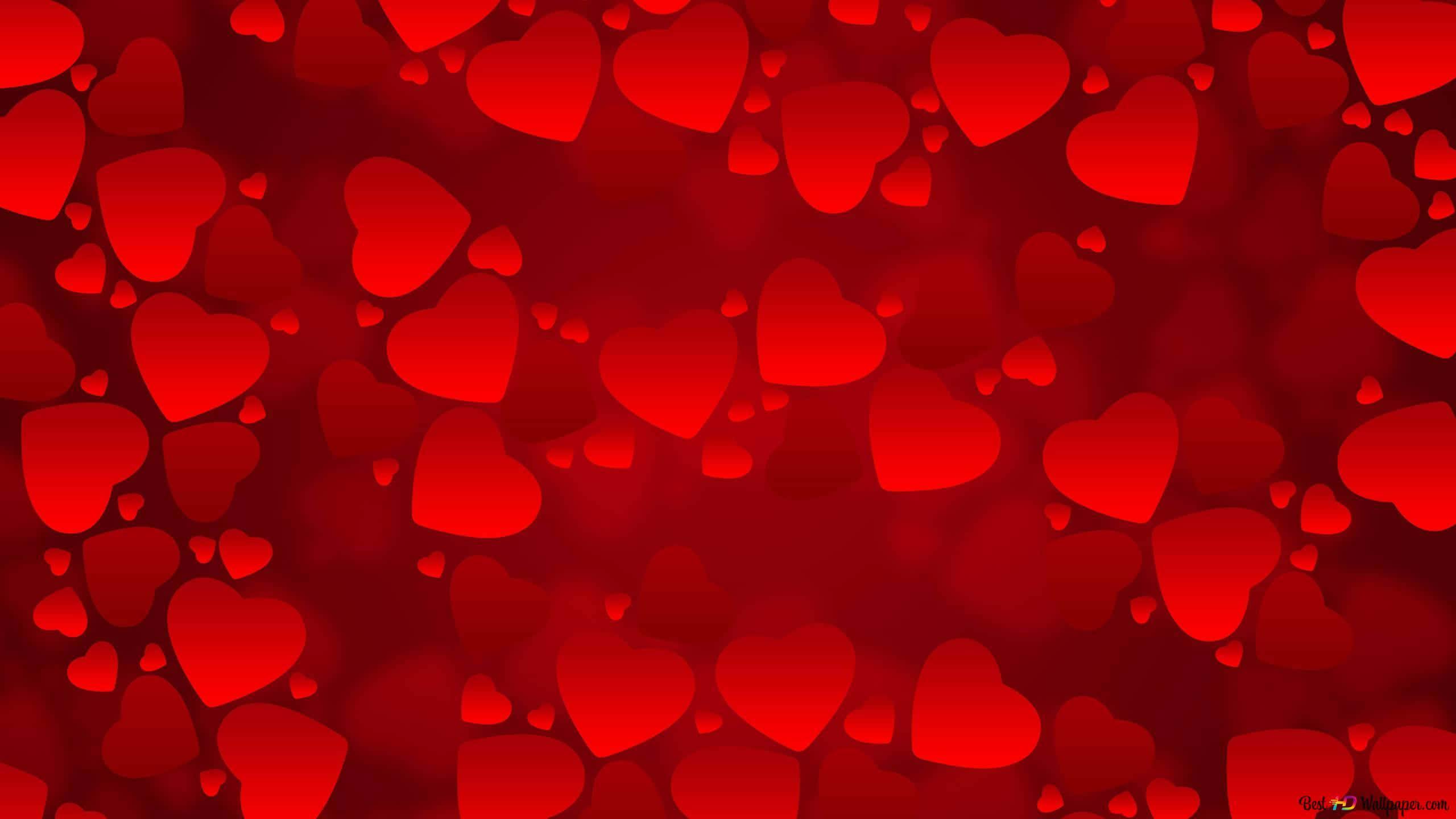 Red Heart 桌布 壁紙 — 充滿柔和發光、大小不一的心形圖案的鮮紅色背景，營造出浪漫夢幻的氛圍。