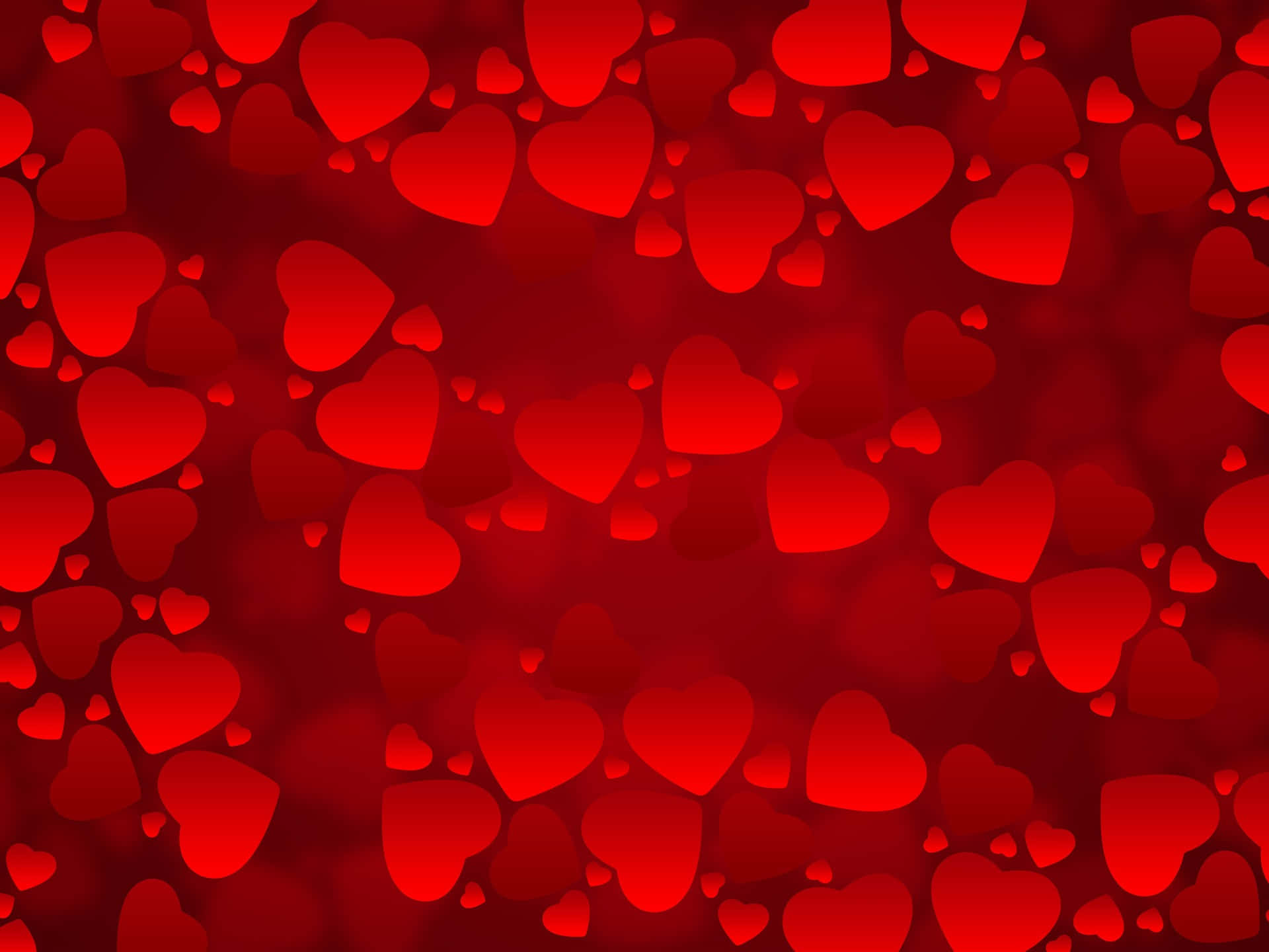 Romantic Love 桌布 壁紙 — 充滿柔和發光心形圖案的鮮紅色背景，心形大小各異，營造浪漫夢幻的氛圍。