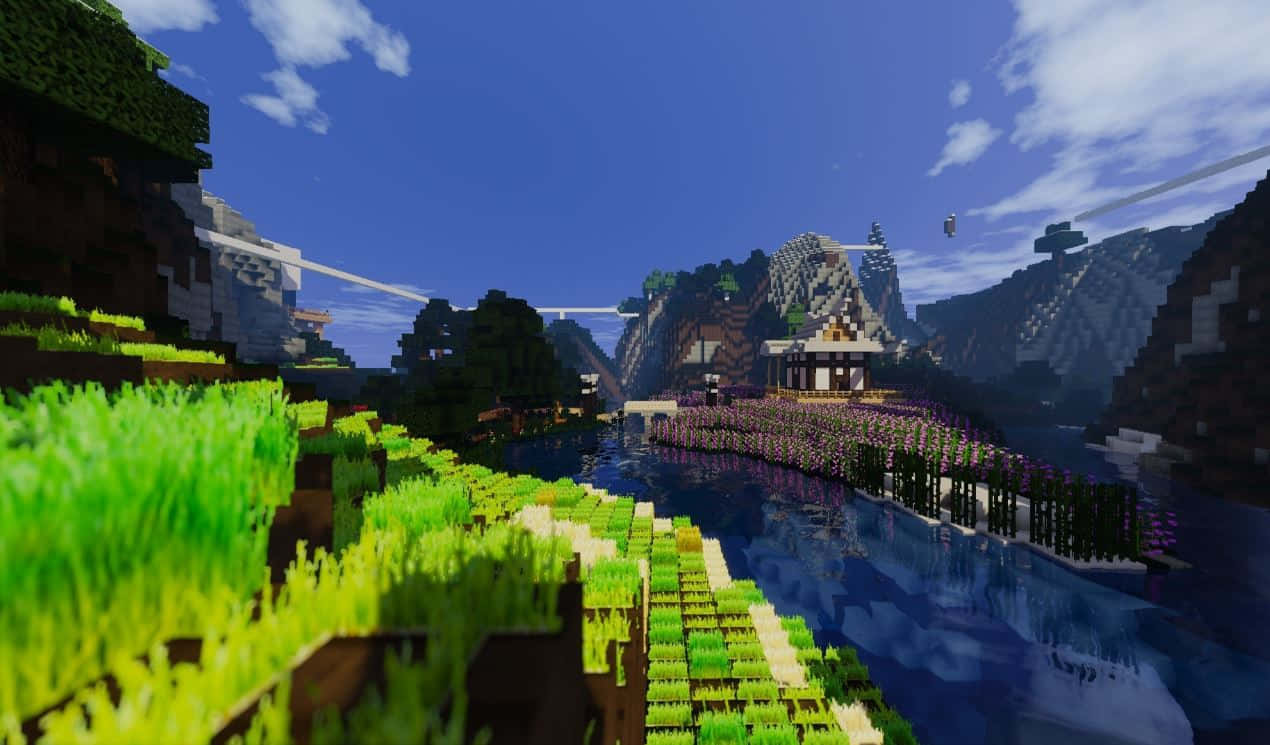 Minecraft Pixel Art 桌布 壁紙 — 充滿活力的Minecraft風景，有像素化的山脈、河流和一座木橋，在清澈的藍天下。