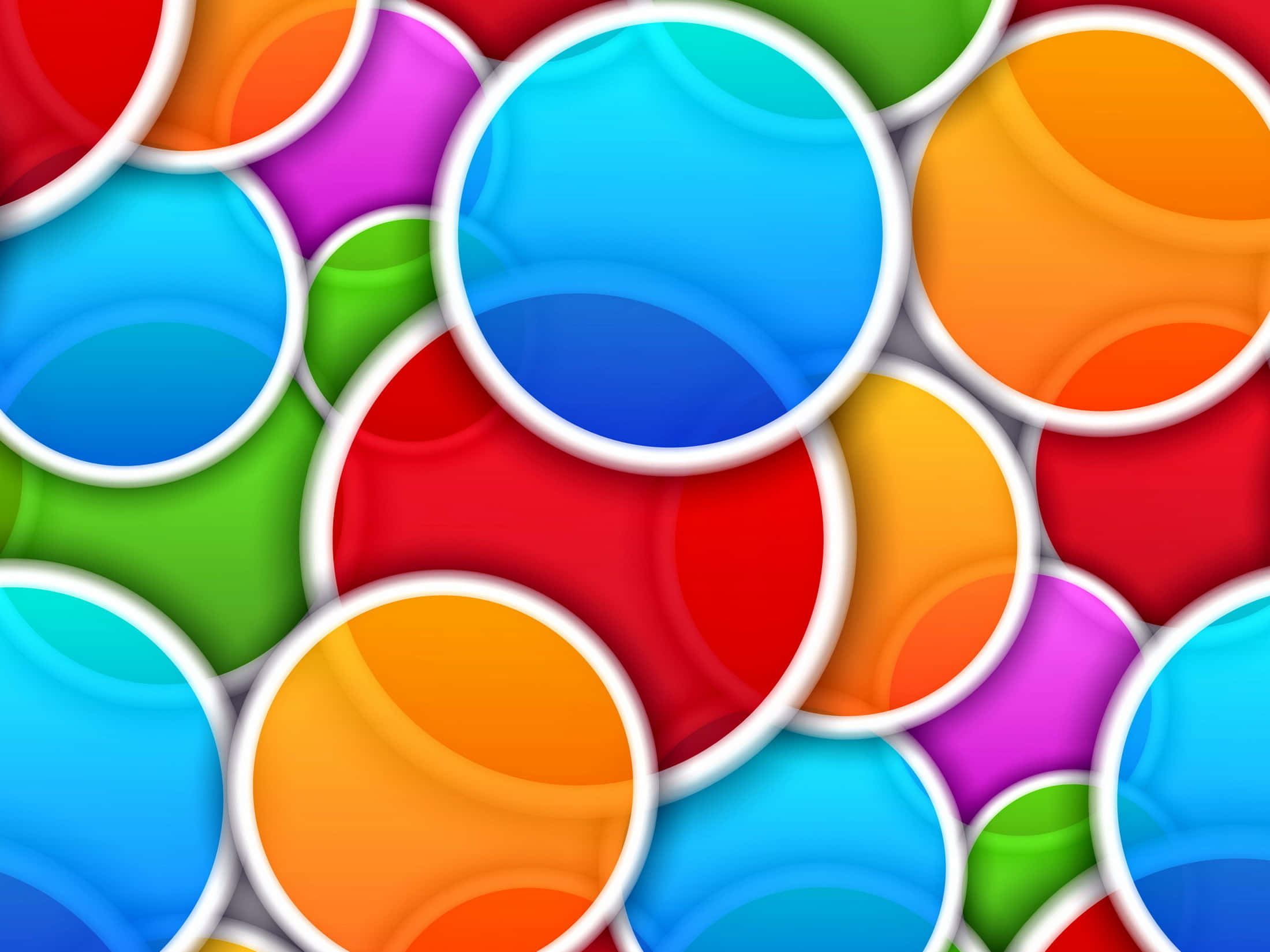Circle 桌布 壁紙 — 充滿活力的光澤圓圈以彩虹色調重疊，帶有白色邊框，營造出俏皮的數位圖案。