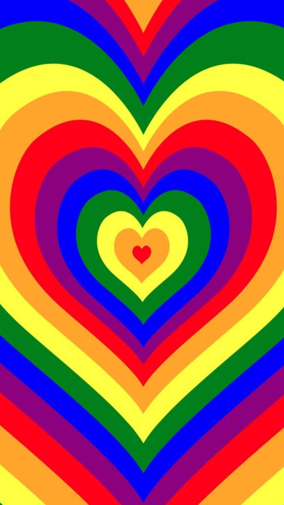 Rainbow Heart 桌布 壁紙 — 充滿活力的同心彩虹心形以迷幻圖案向外輻射，色彩大膽飽和。