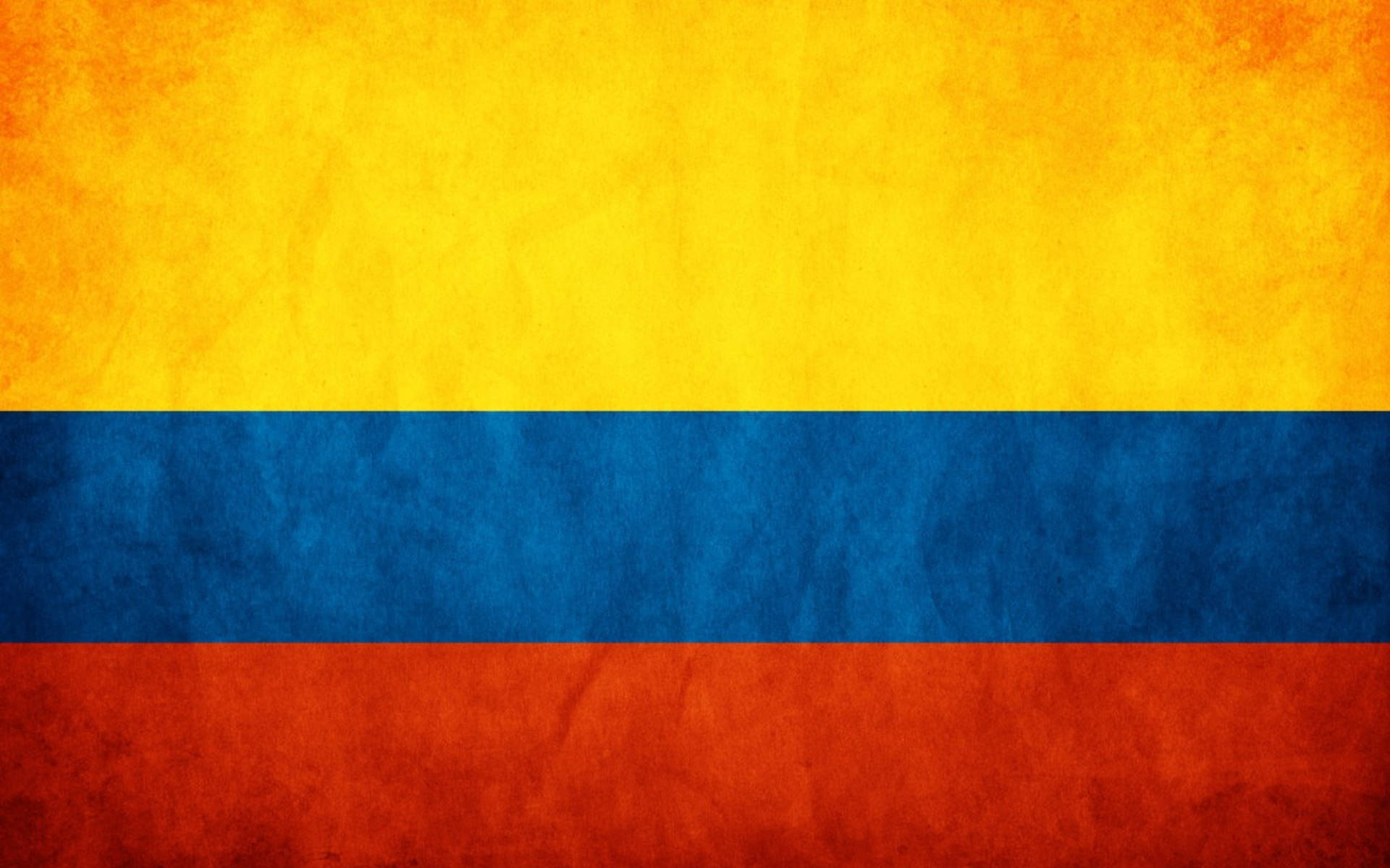 Colombia Flag 桌布 壁紙 — 充滿活力的哥倫比亞國旗，帶有紋理的黃色、藍色和紅色條紋，呈現陳舊布料外觀。