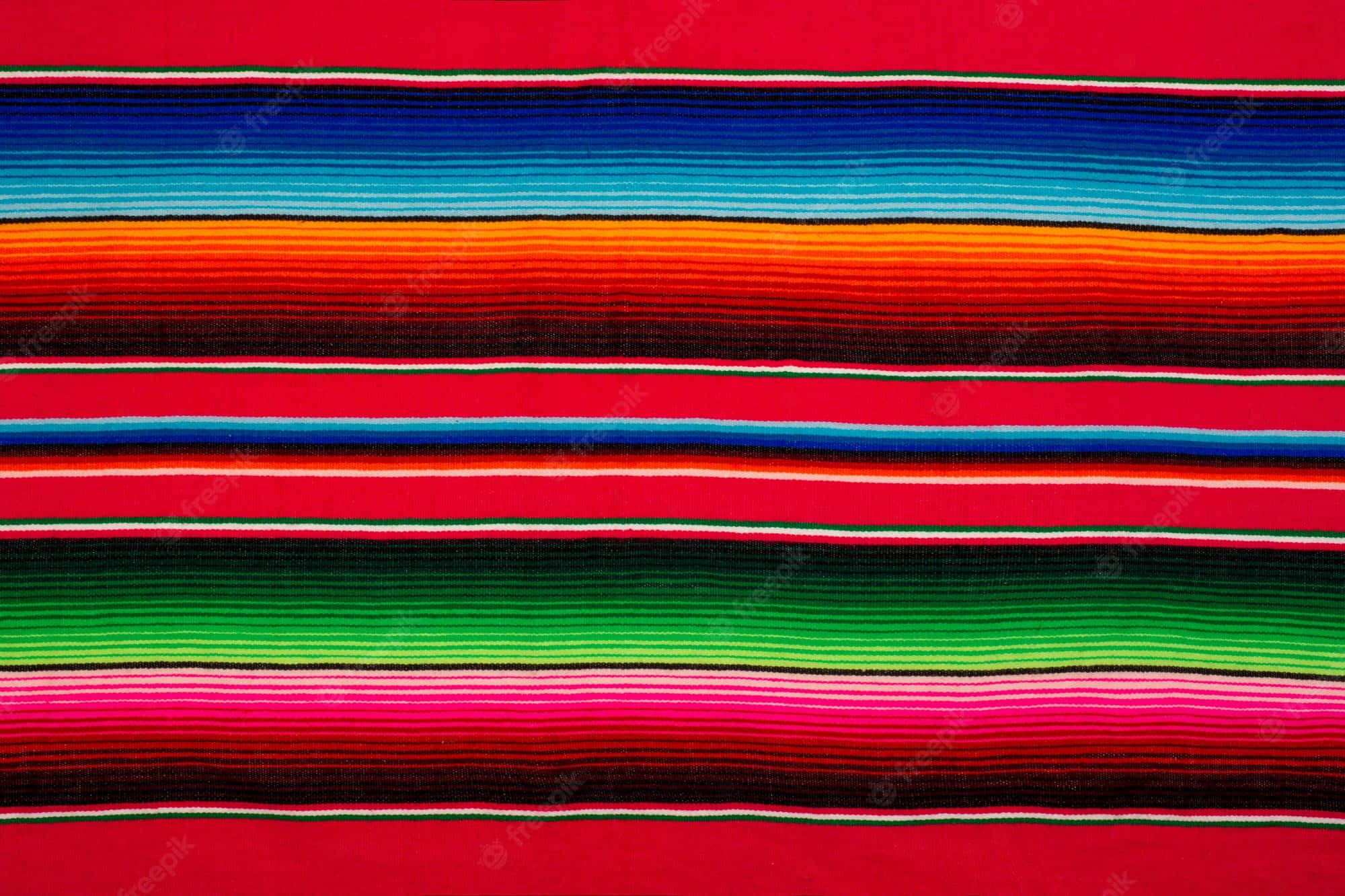 Serape 桌布 壁紙 — 充滿活力的多色條紋紡織品，近距離展示大膽的紅色、藍色、橙色、綠色和粉紅色條帶。