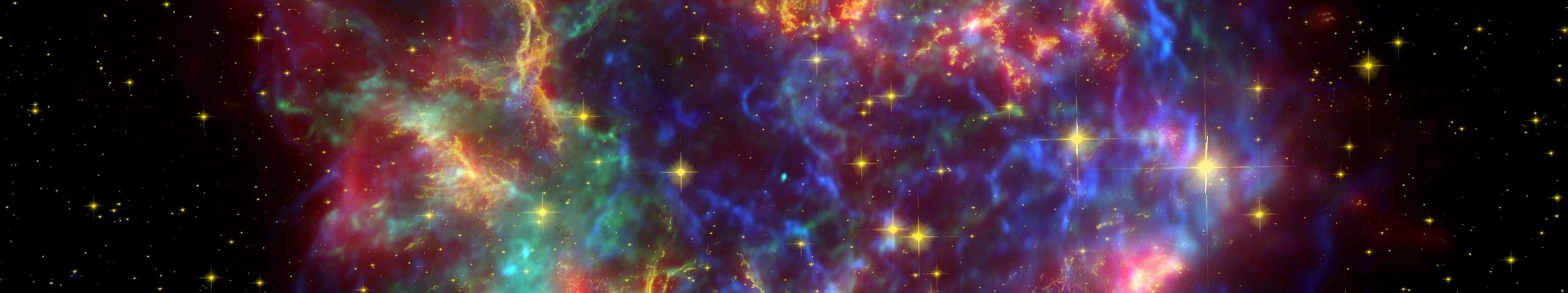 桌布 壁紙 — 充滿活力的宇宙星雲，紅色、藍色和綠色的氣體在星空中旋轉發光。