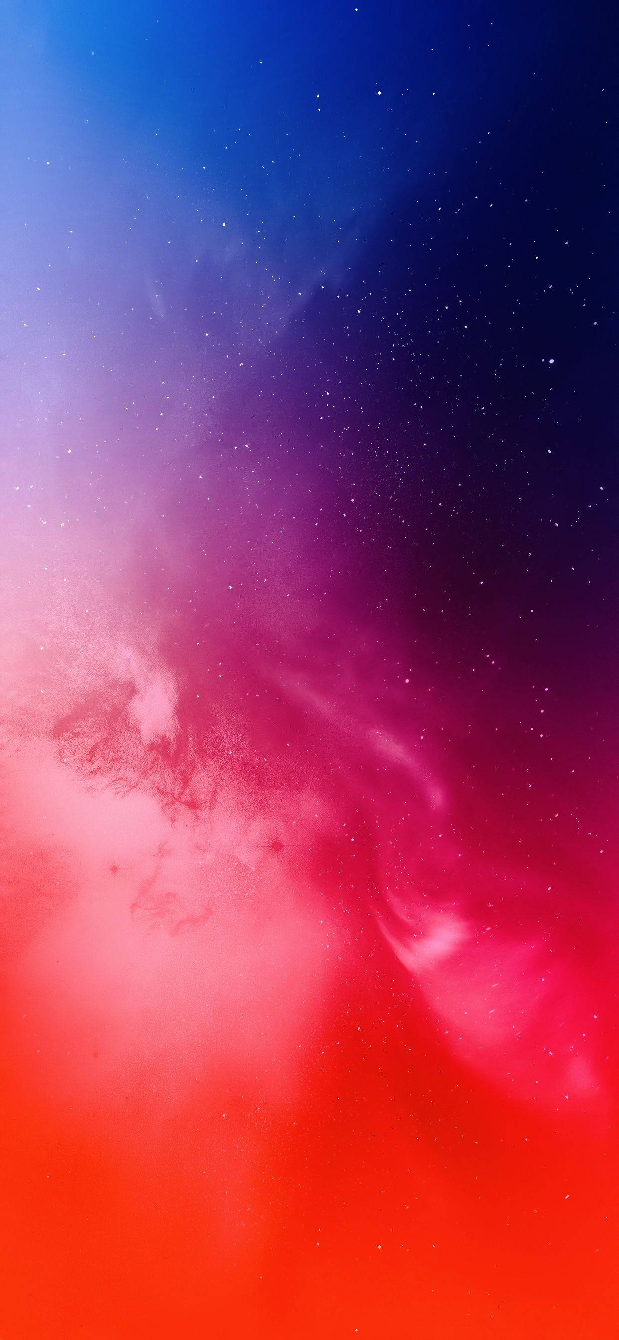 iPhone 11 Pro Max 桌布 壁紙 — 充滿活力的宇宙星雲從火紅色旋轉到深藍色，發光的星星散落在天際。