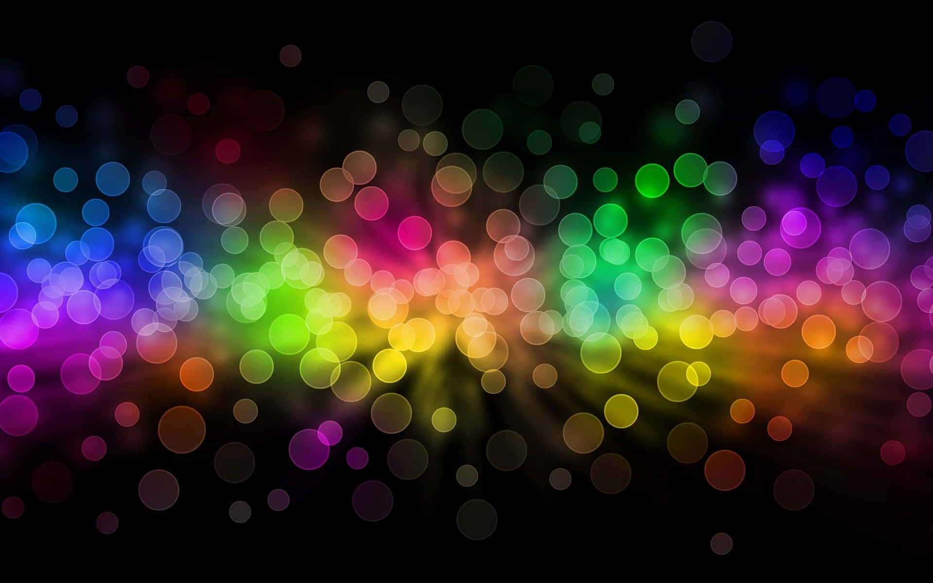 Bokeh 桌布 壁紙 — 充滿活力的彩虹散景燈光在深黑色背景上柔和發光，營造出夢幻般的抽象光芒。