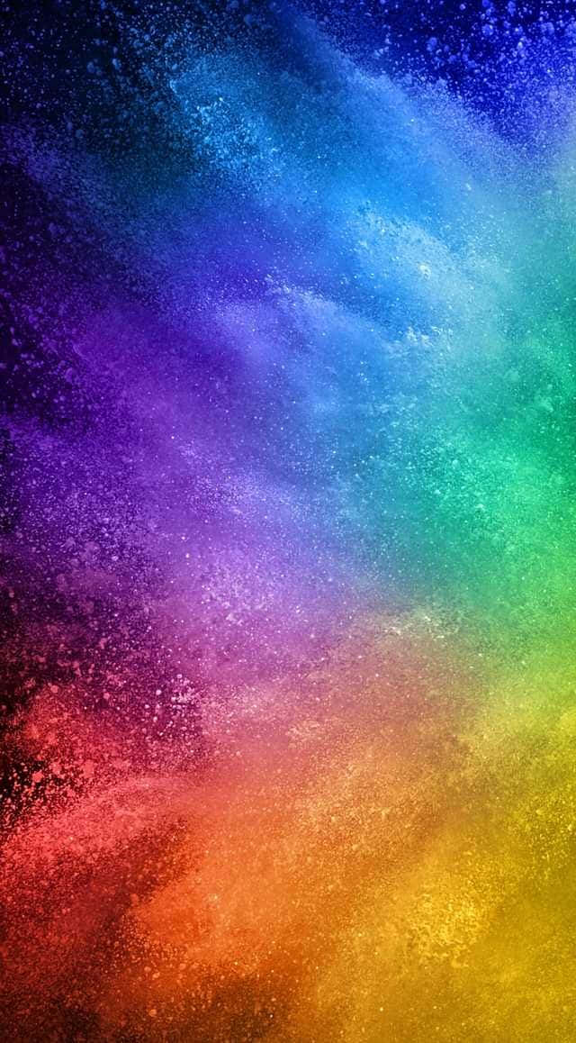 Colourful 桌布 壁紙 — 充滿活力的彩虹色粉末在深色背景上對角線爆炸，形成動態的抽象爆發。
