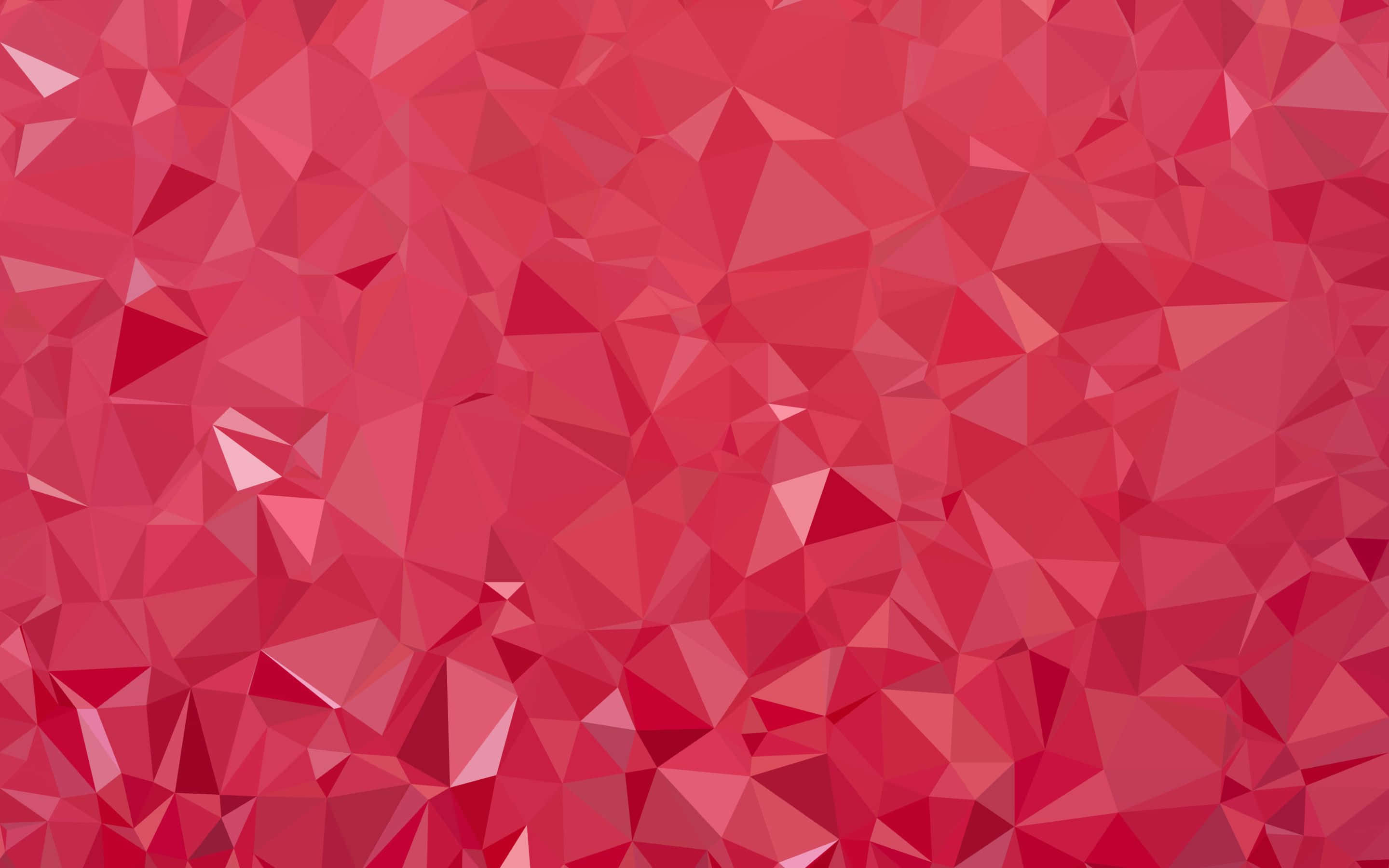 Polygon 桌布 壁紙 — 充滿活力的抽象壁紙，由層疊的紅色三角形切面組成，營造出動態的低多邊形紋理。