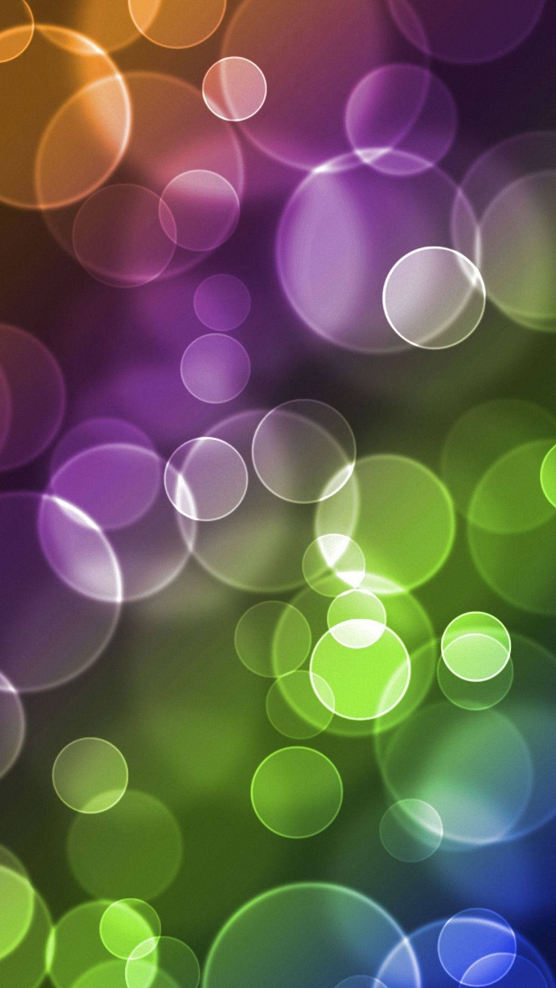 Bubbles 桌布 壁紙 — 充滿活力的抽象散景燈光，以紫色、綠色和橙色的漸變色調柔和地照亮整個畫面。