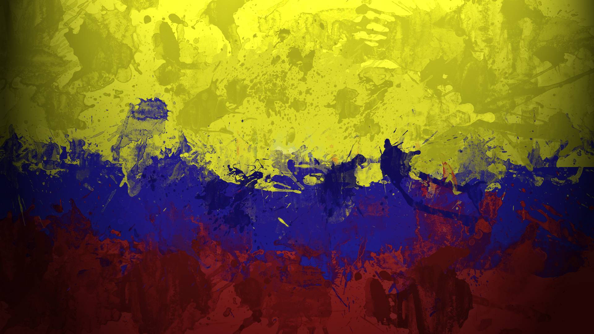Colombia Flag 桌布 壁紙 — 充滿活力的抽象桌布，帶有鮮明的黃色、藍色和紅色油漆飛濺，營造出動態的紋理背景。