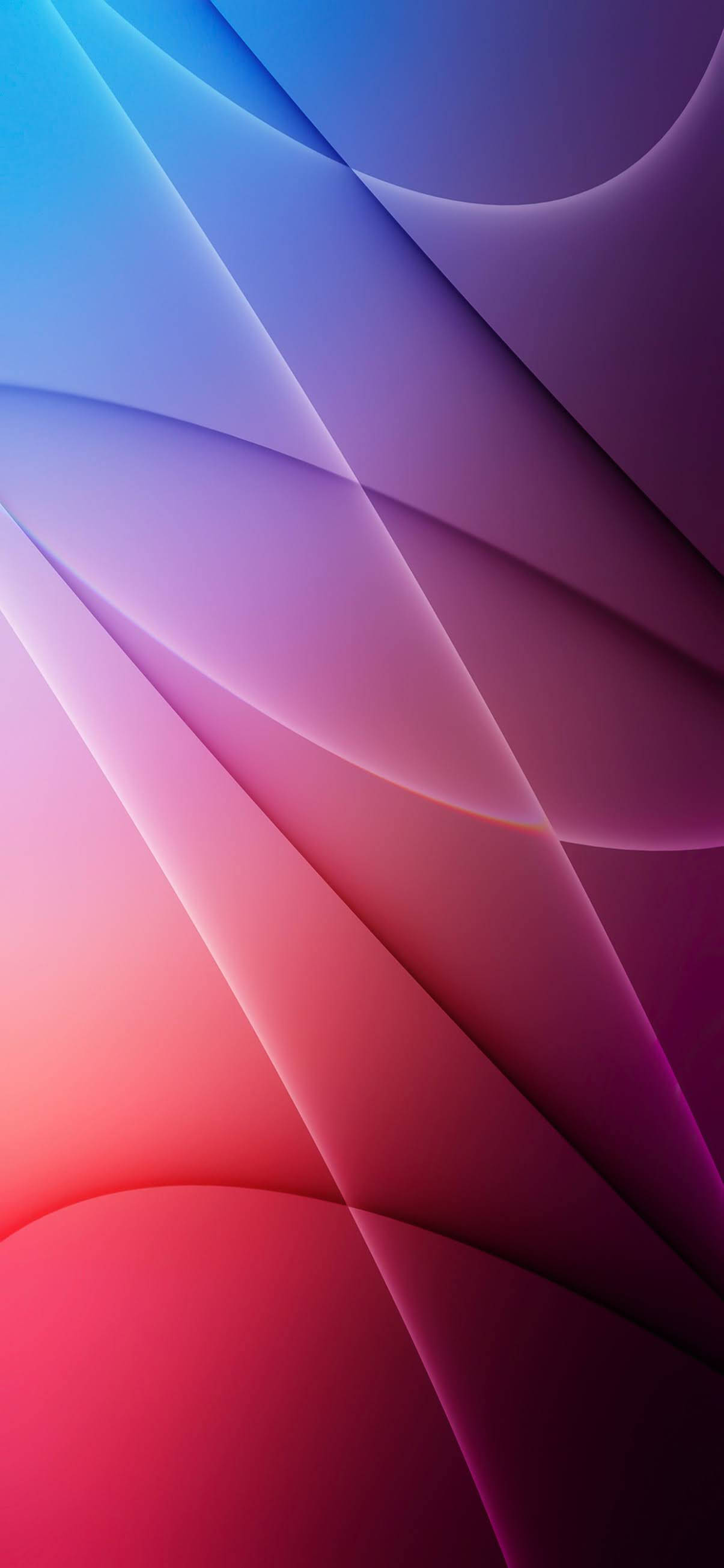 iOS 15 桌布 壁紙 — 充滿活力的抽象波浪從冷藍色到暖紅色以平滑漸變對角流動。