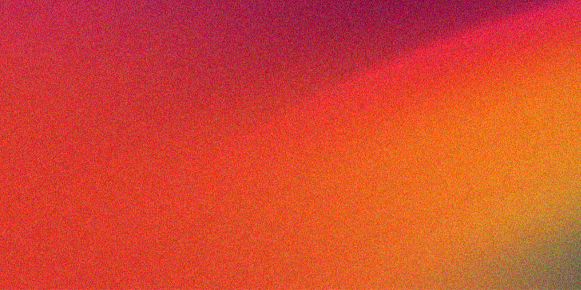 Abstract Warm Color Gradient Background Texture with Subtle Grain 壁紙 — 充滿活力的抽象漸層從深洋紅色到火橙色對角流動，帶有微妙的顆粒紋理。
