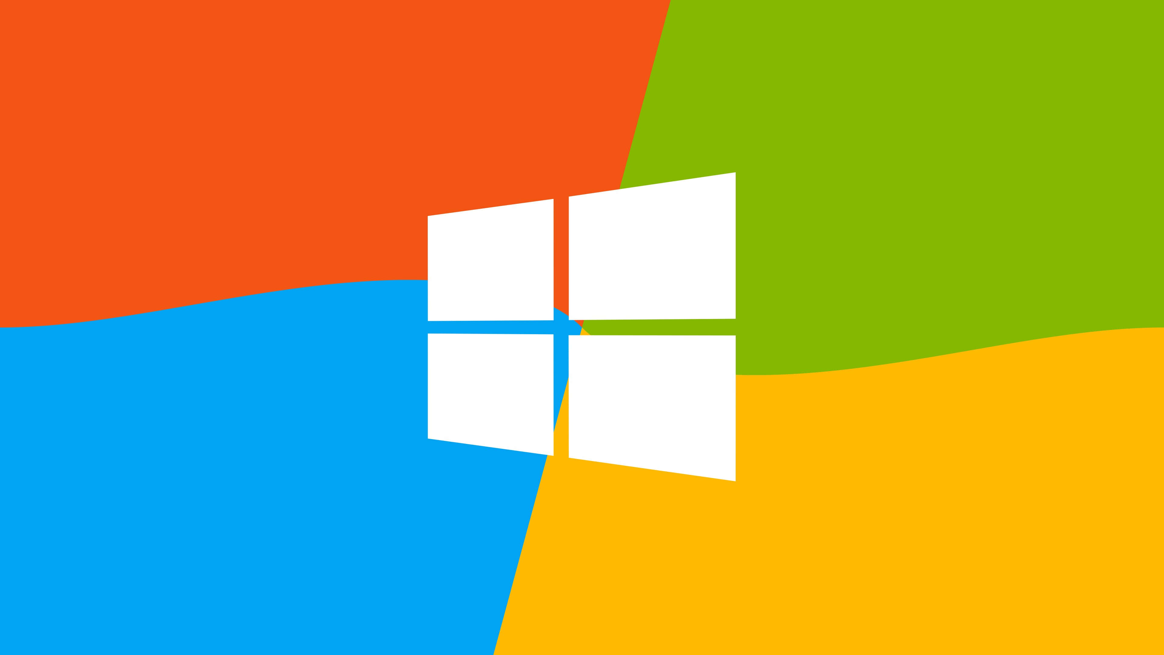 Windows 10 桌布 壁紙 — 充滿活力的抽象背景，帶有鮮明的橙色、綠色、藍色和黃色部分，中央有一個白色Windows標誌。