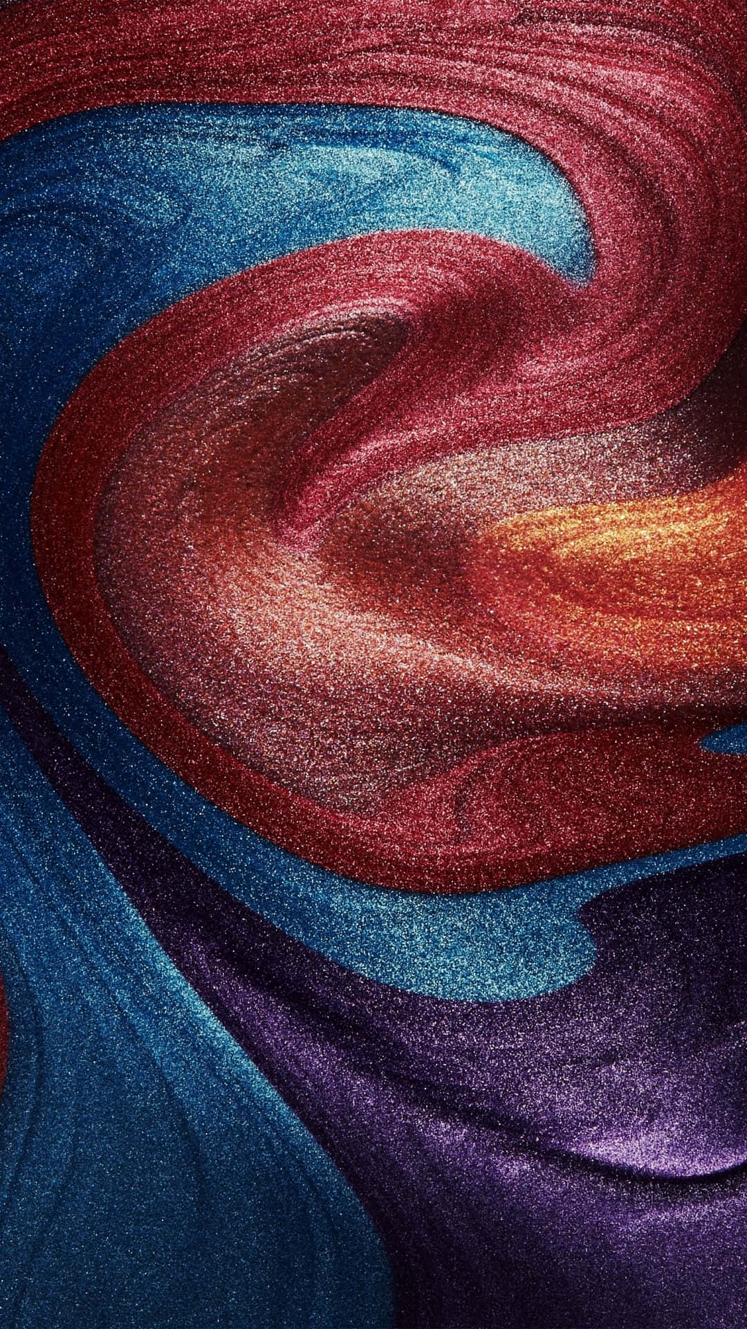Textured 桌布 壁紙 — 充滿活力的旋轉抽象圖案，閃亮的紅色、藍色和紫色色調在畫面中動態流動。
