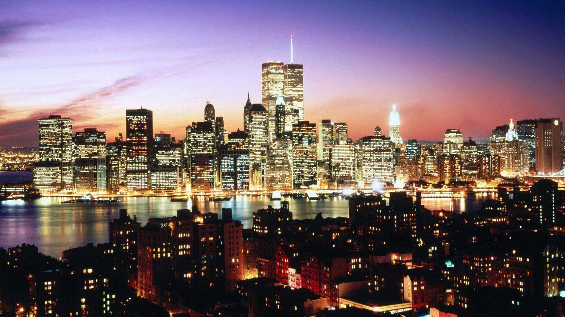 New York 桌布 壁紙 — 充滿活力的暮色城市景觀，發光的摩天大樓在紫色和橙色的天空下倒映在水中。