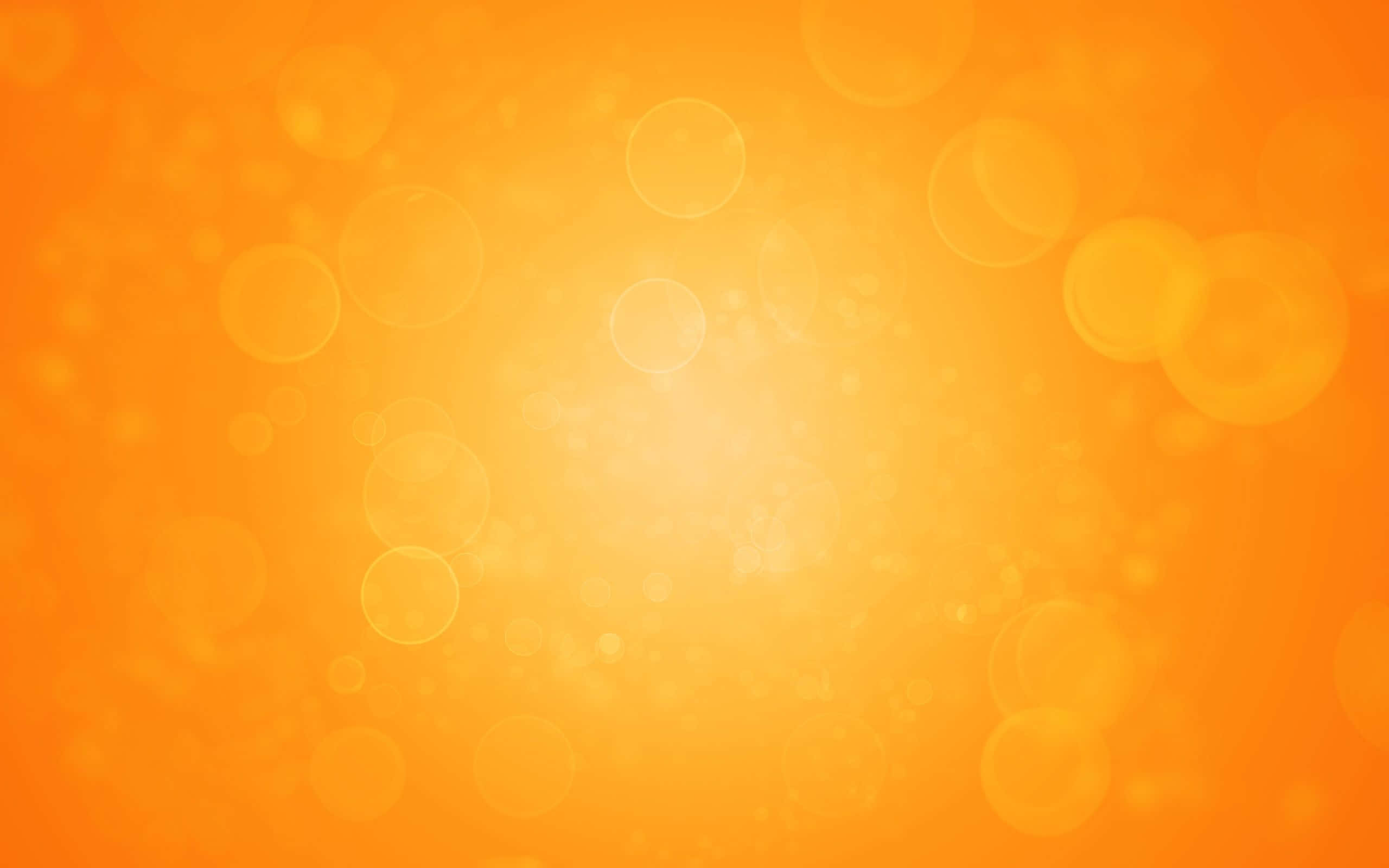 Orange And Yellow 桌布 壁紙 — 充滿活力的橙色漸層背景，帶有柔和發光的散景圓圈，營造溫暖夢幻的氛圍。