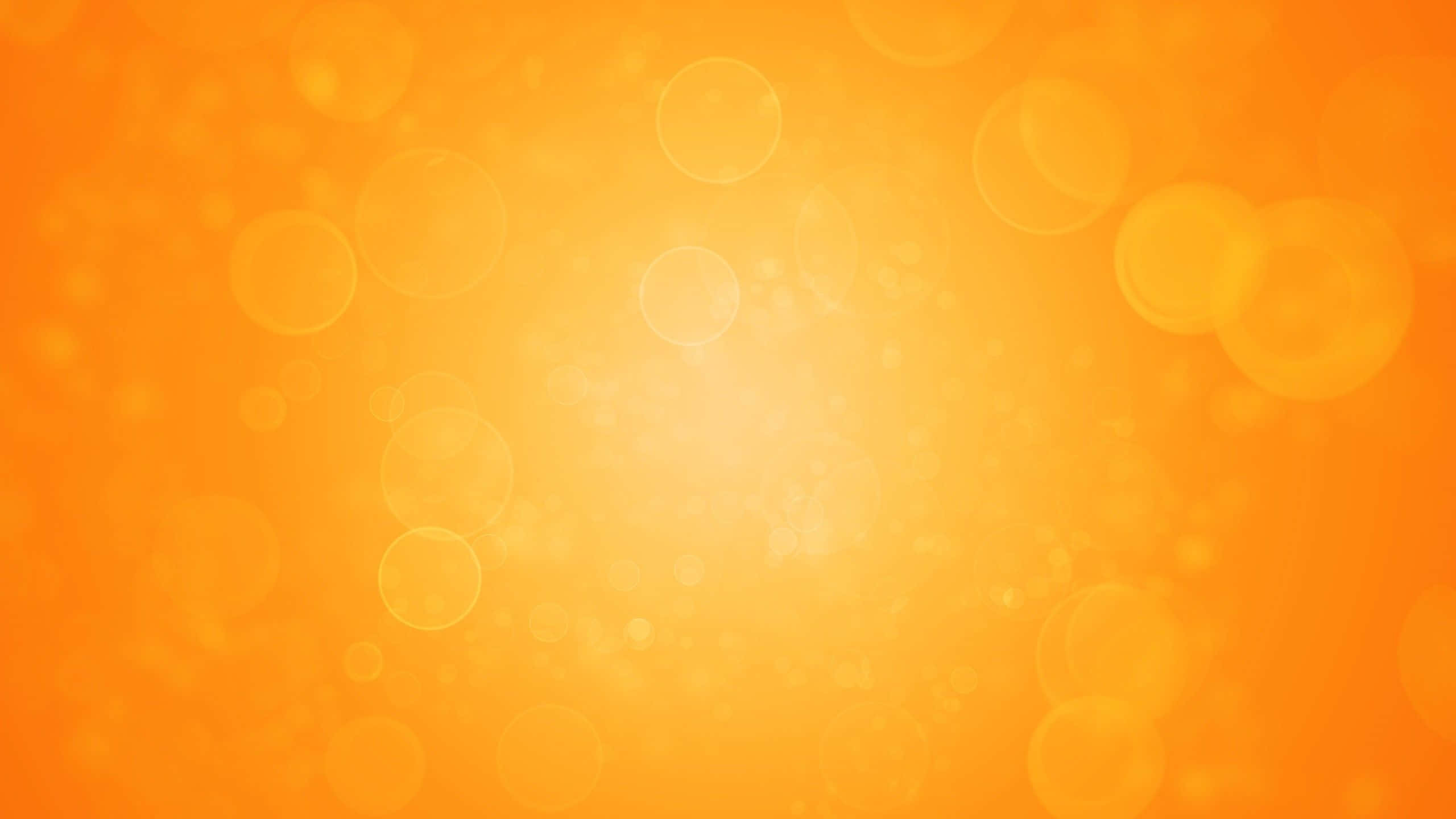 Bokeh 桌布 壁紙 — 充滿活力的橙色漸層背景，帶有柔和發光的散景圓圈，營造出溫暖夢幻的氛圍。