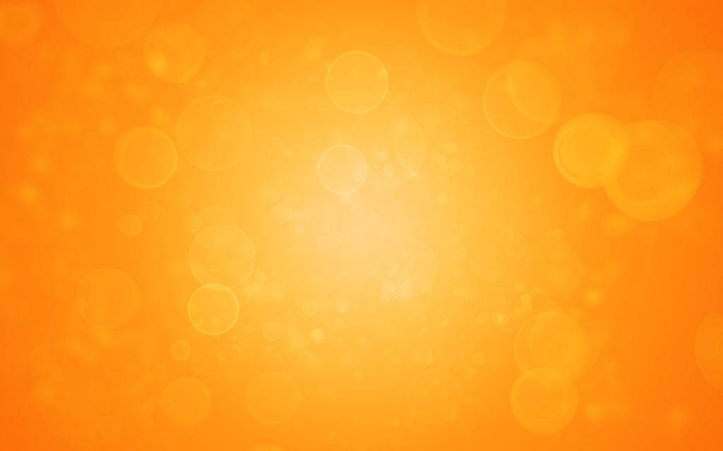 Orange And Yellow 桌布 壁紙 — 充滿活力的橙色漸變背景，帶有柔和發光的散景圓圈，營造溫暖夢幻的氛圍。
