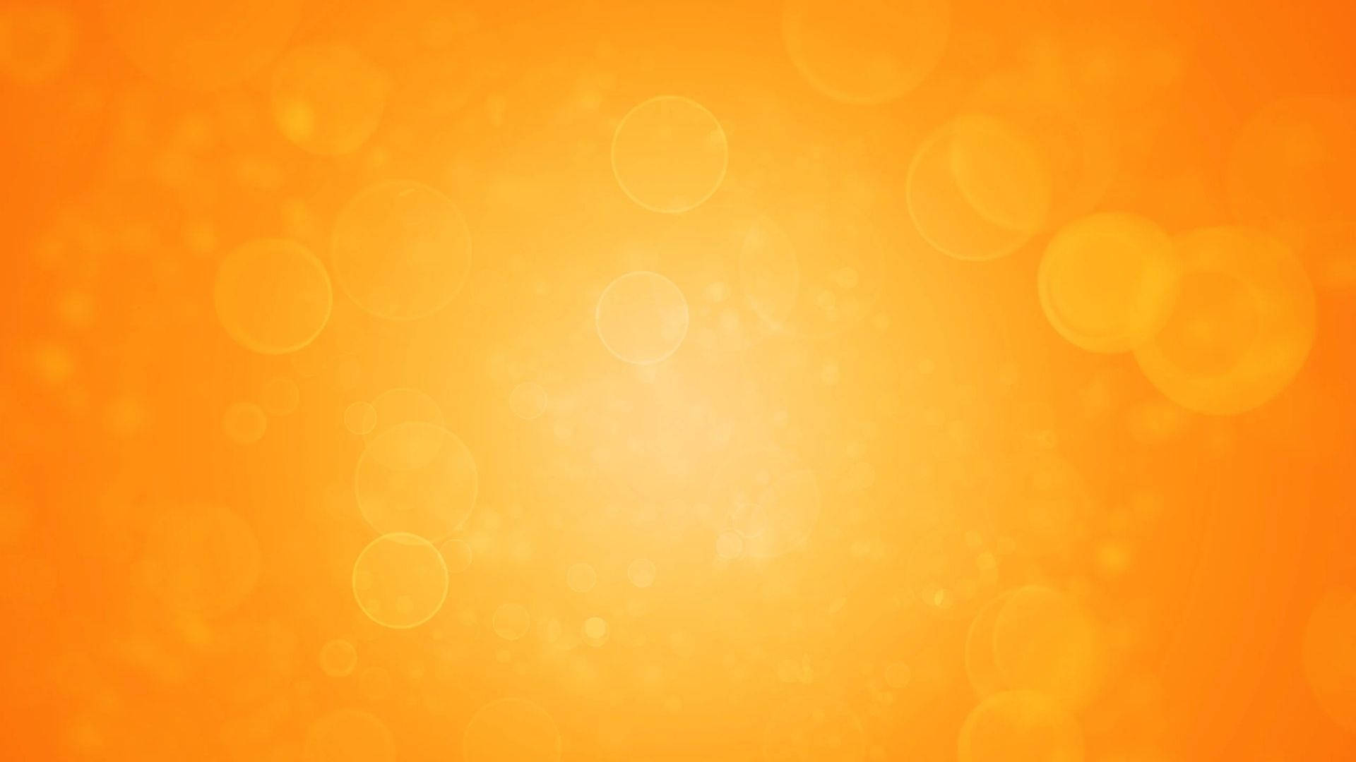Orange 桌布 壁紙 — 充滿活力的橙色漸變背景，帶有柔和發光的散景圓圈，營造溫暖夢幻的氛圍。