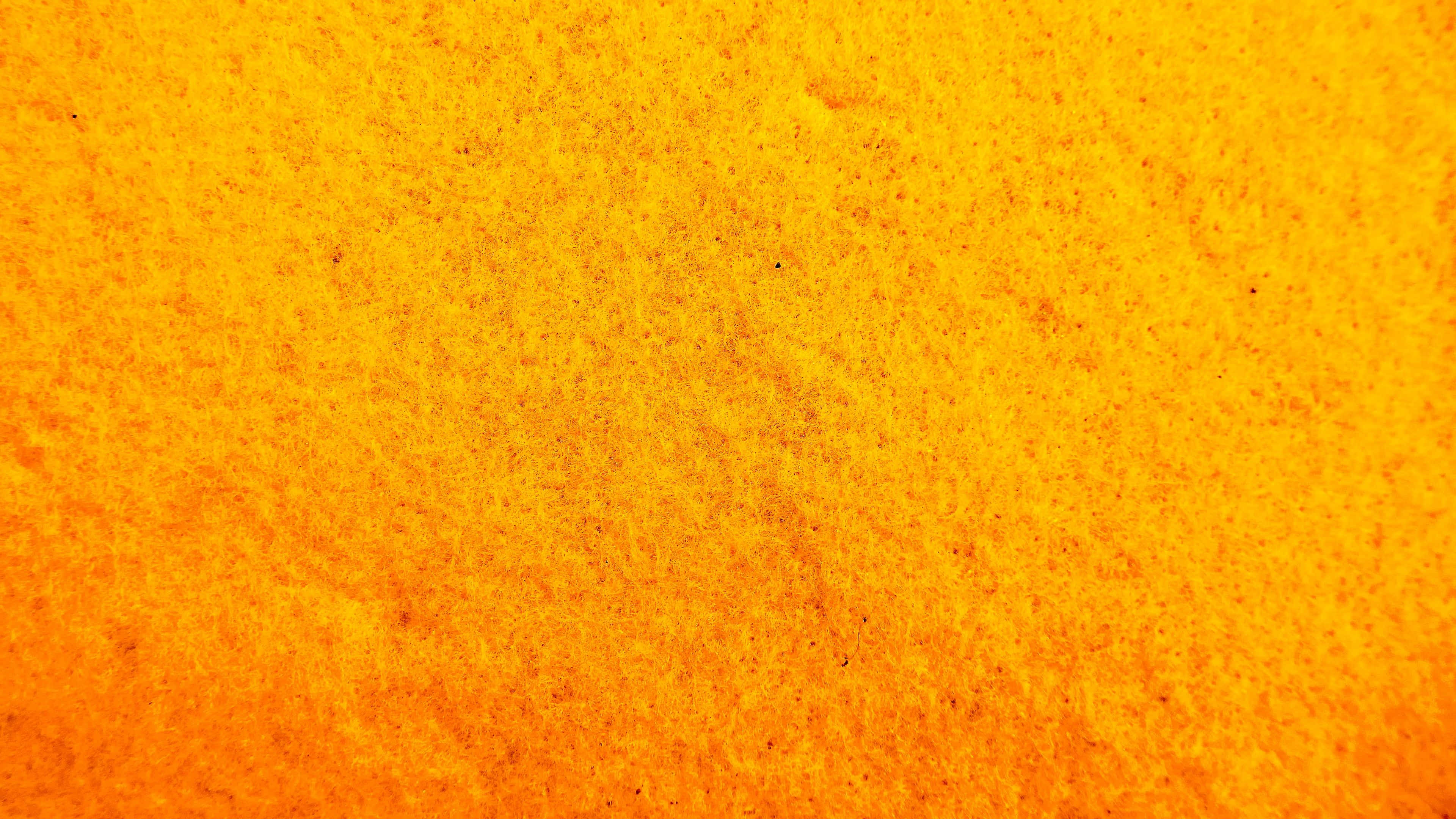 Yellow Texture 桌布 壁紙 — 充滿活力的橙色紋理表面，帶有細微斑點和漸變色調。