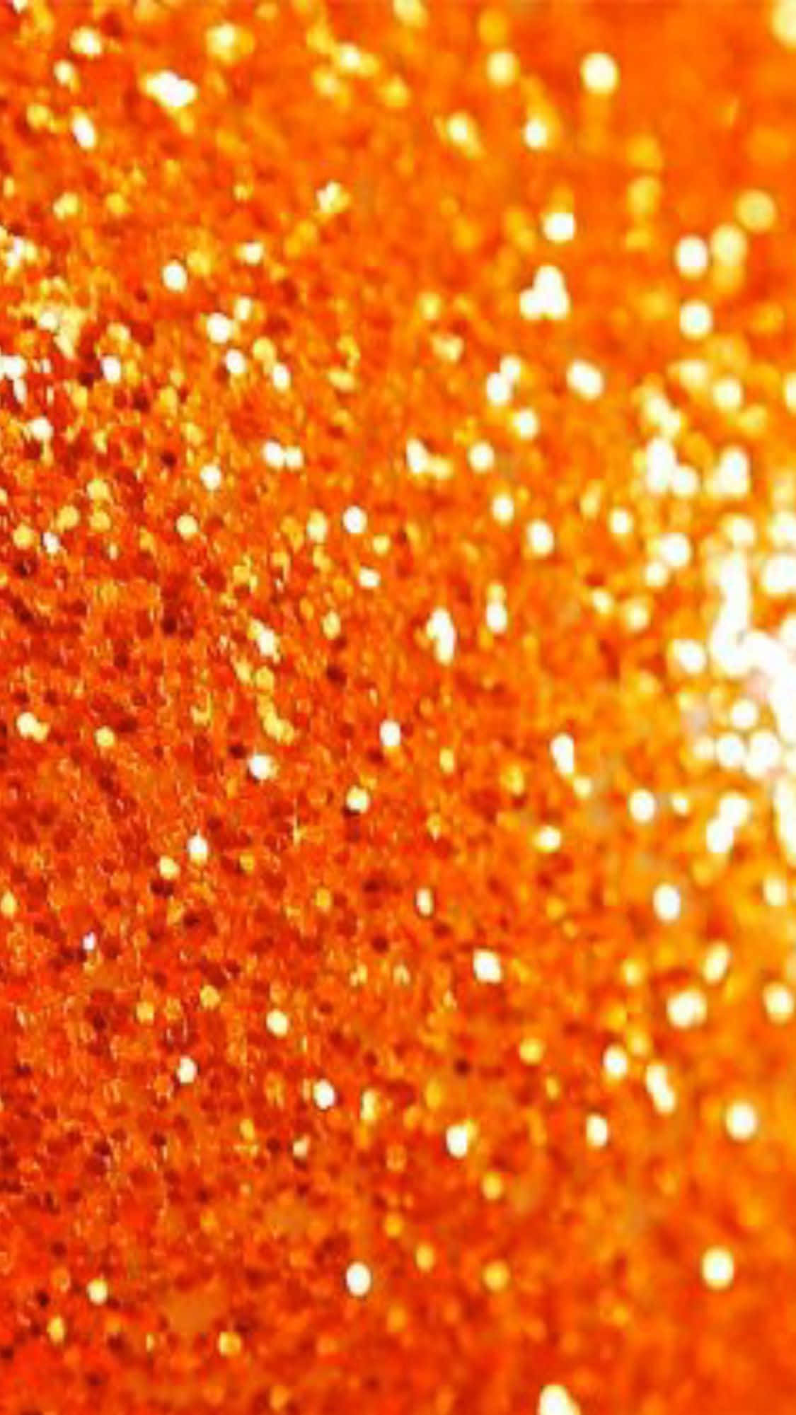 Orange Glitter 桌布 壁紙 — 充滿活力的橙色閃粉特寫，帶有明亮的白色斑點捕捉光線。