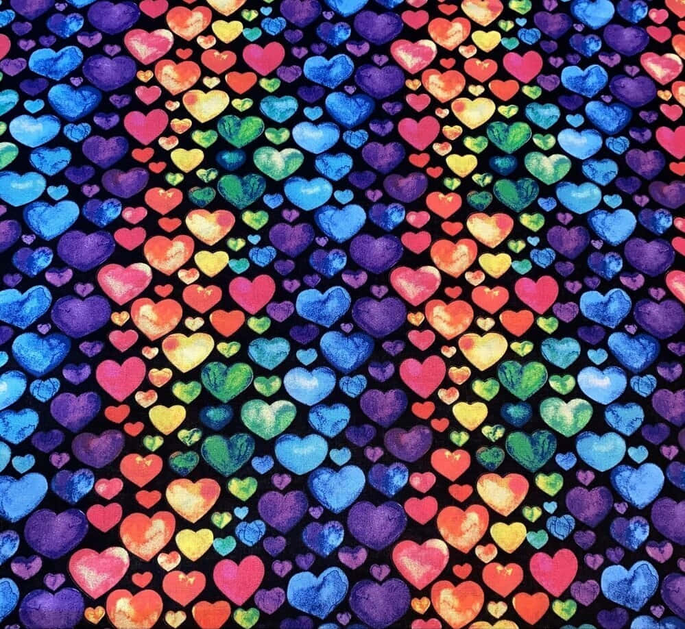 Rainbow Heart 桌布 壁紙 — 充滿活力的水彩愛心以彩虹色調密集覆蓋黑色背景，營造出歡樂的圖案。