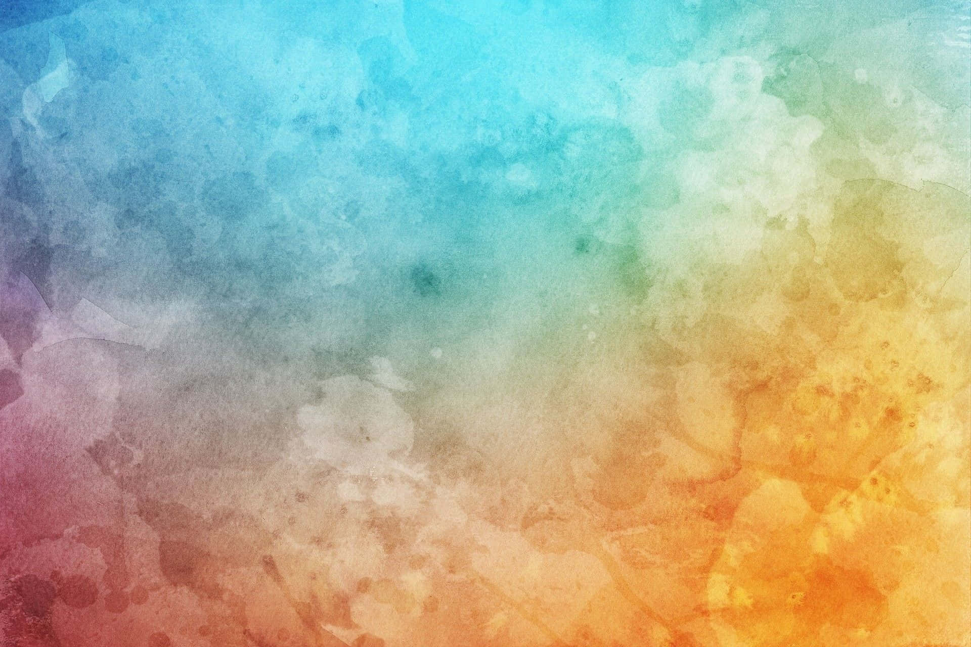 Blue Watercolor 桌布 壁紙 — 充滿活力的水彩漸層，將冷色調的藍色和藍綠色與溫暖的橙色和粉紅色融合在柔和、有紋理的洗滌中。