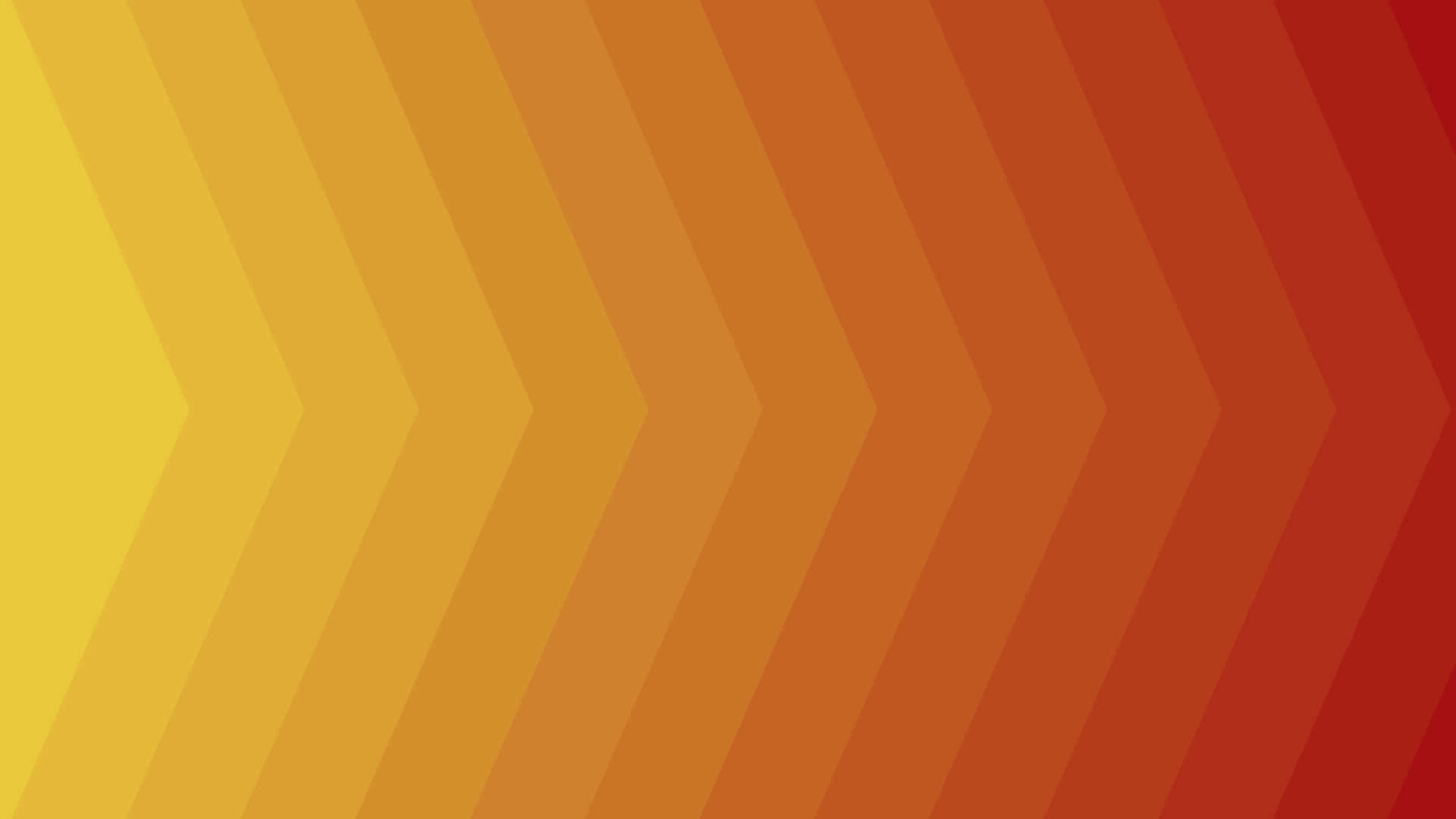 Orange And Yellow 桌布 壁紙 — 充滿活力的漸變V形圖案從黃色到深紅色對角流動，呈現現代抽象設計。