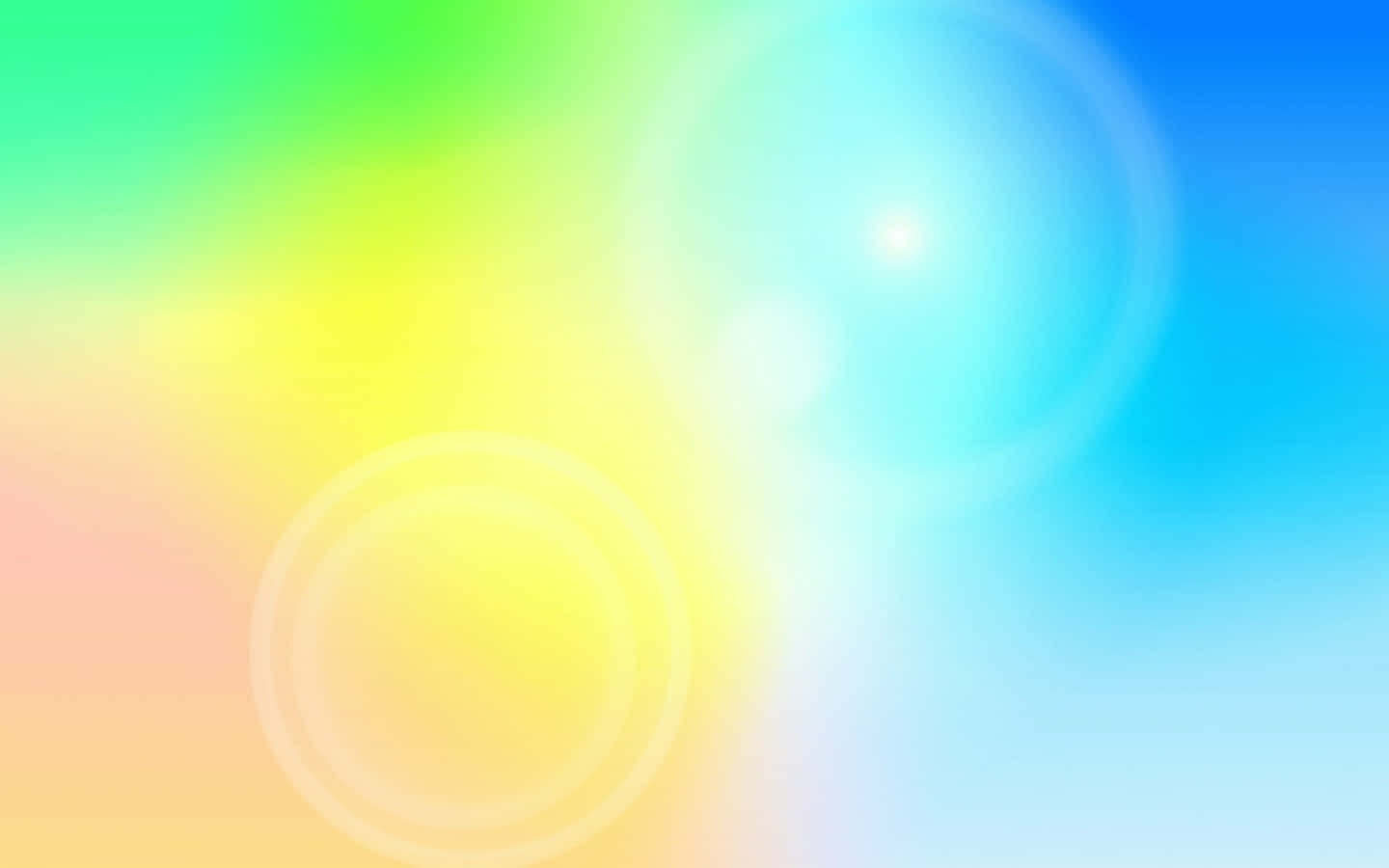 Light 桌布 壁紙 — 充滿活力的漸變背景，帶有柔和的鏡頭光暈，從綠色過渡到黃色再到藍色。