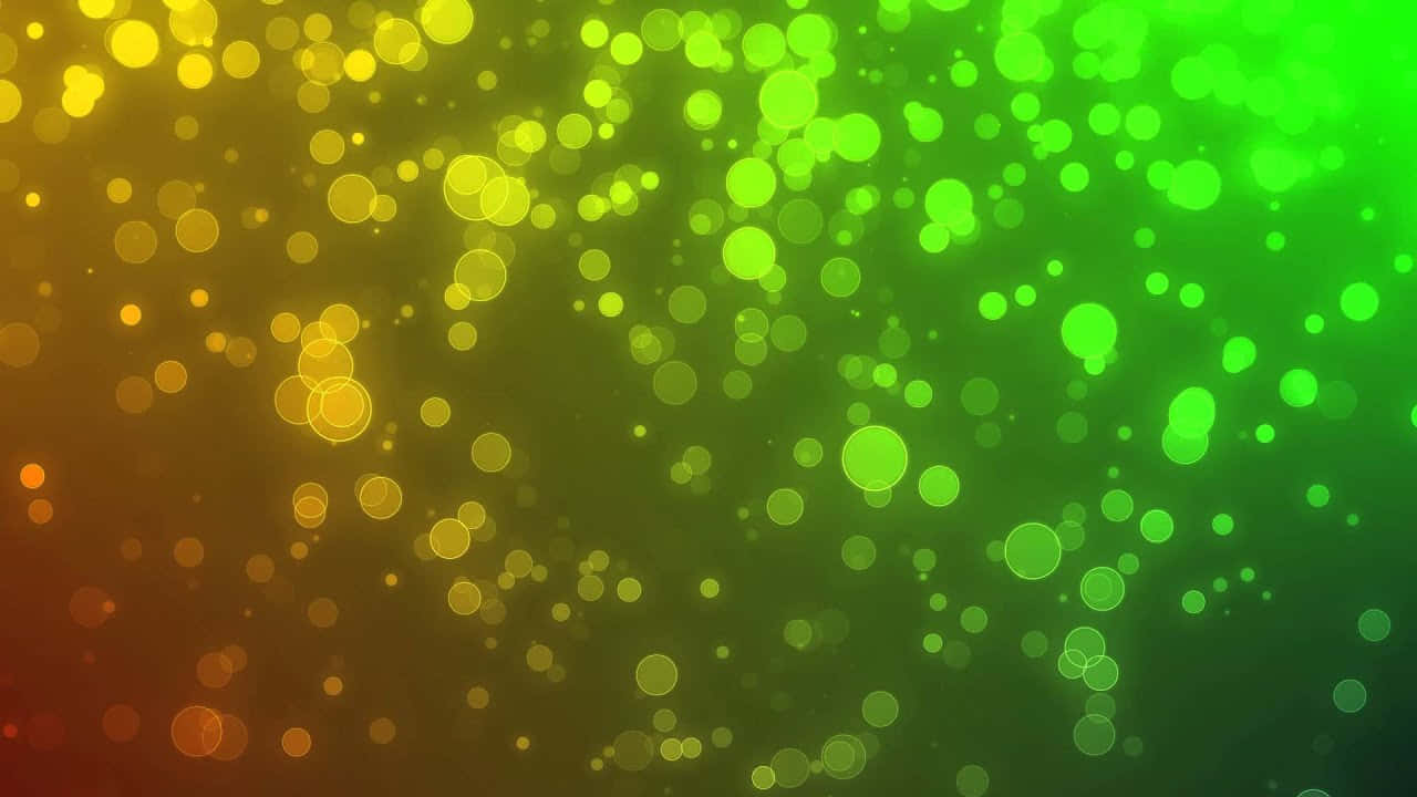 Bokeh 桌布 壁紙 — 充滿活力的漸變背景，發光的黃綠色和橙色散景圓圈漂浮在黑暗的場地上。