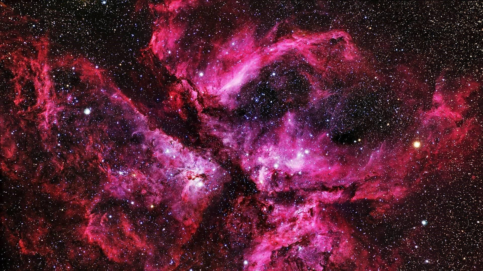 銀河 桌布 壁紙 — 充滿活力的粉紅色和紅色宇宙雲在令人嘆為觀止的深空星雲中，在無數恆星之間旋轉。