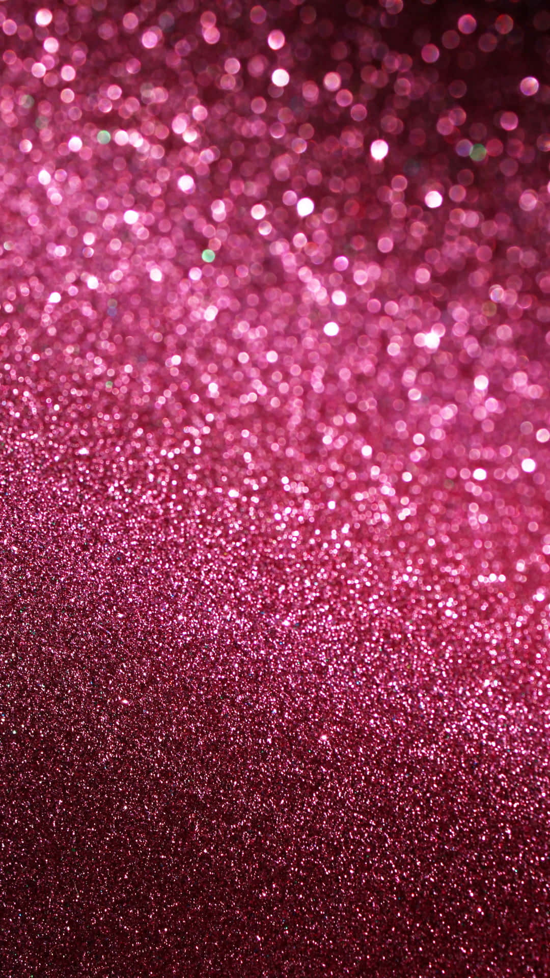 Glitter Pink 桌布 壁紙 — 充滿活力的粉紅色閃粉漸層，帶有散景高光，營造出耀眼的有紋理背景。
