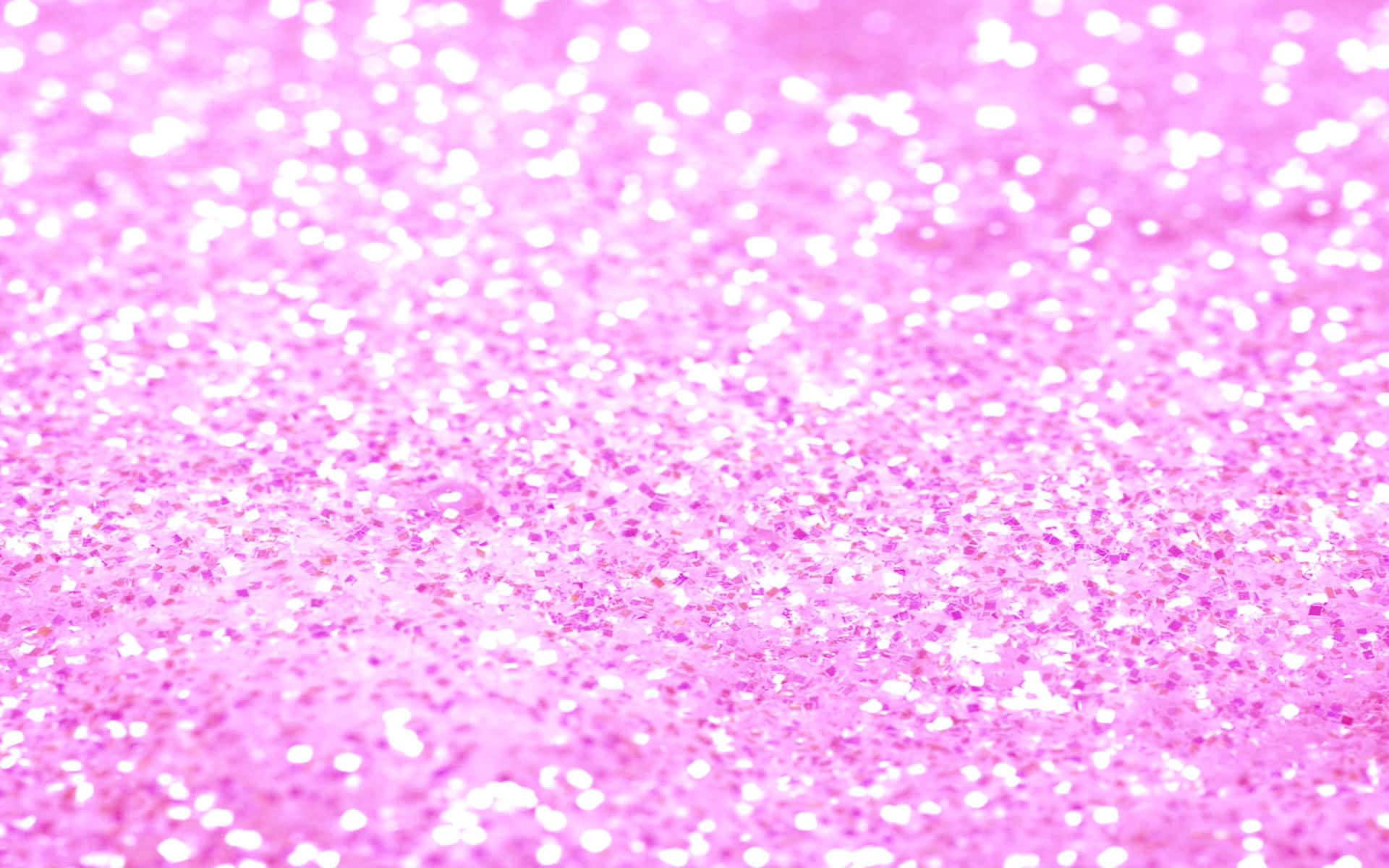 Pink Sparkles 桌布 壁紙 — 充滿活力的粉紅色閃粉特寫，帶有閃爍的白色亮點，營造出閃閃發光的紋理表面。