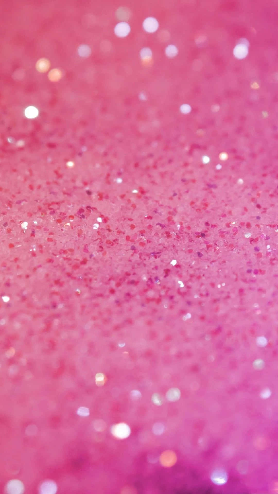 Pink Phone 桌布 壁紙 — 充滿活力的粉紅色閃粉特寫，閃爍的高光營造出閃閃發光的紋理表面。