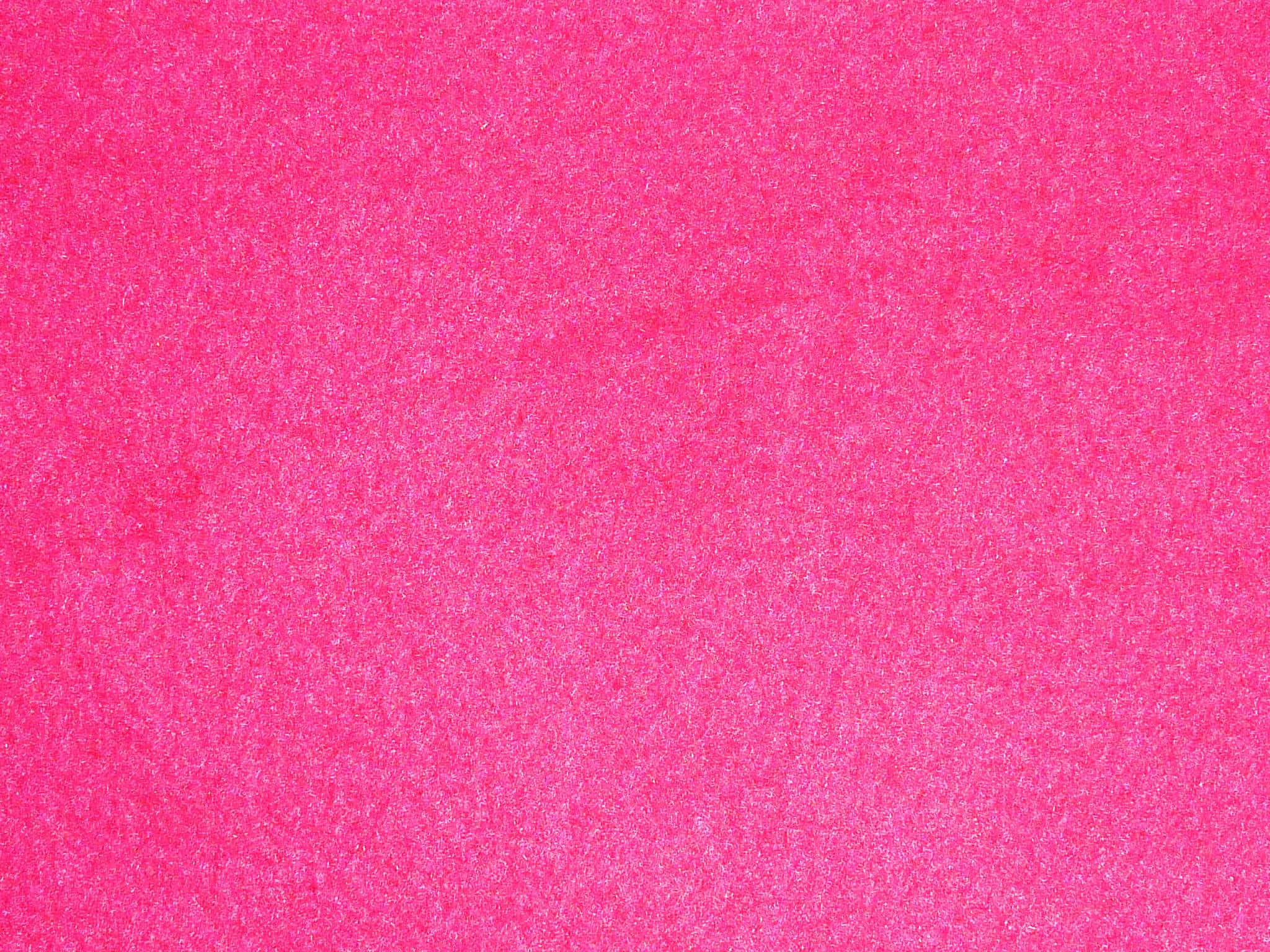 Plain Pink 桌布 壁紙 — 充滿活力的粉紅色閃粉質感填滿畫面，閃爍的顆粒營造出大膽閃亮的表面。