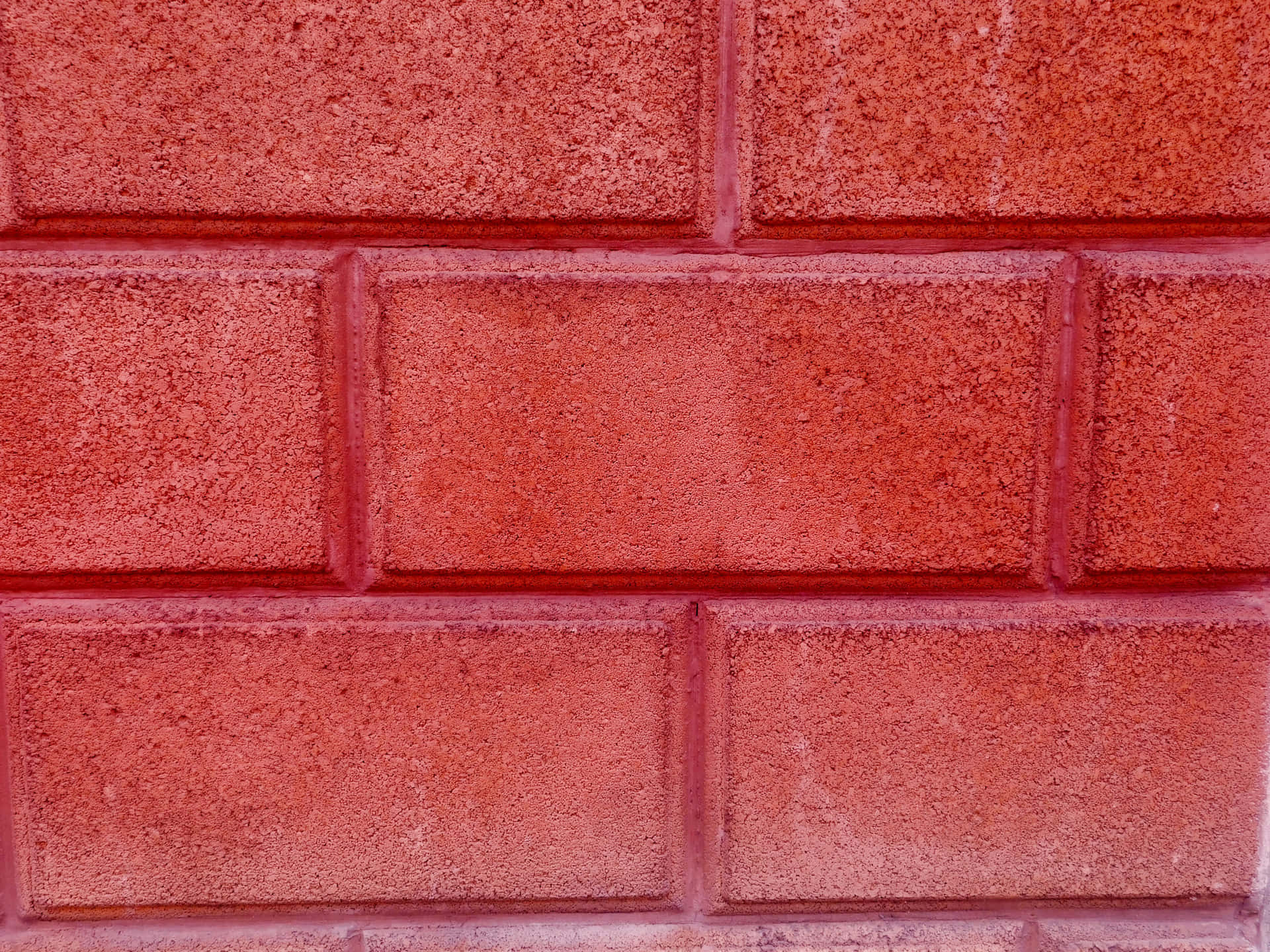 Red stone texture 壁紙 — 充滿活力的紅磚牆特寫，帶有紋理砂漿線條和均勻的長方形磚塊。