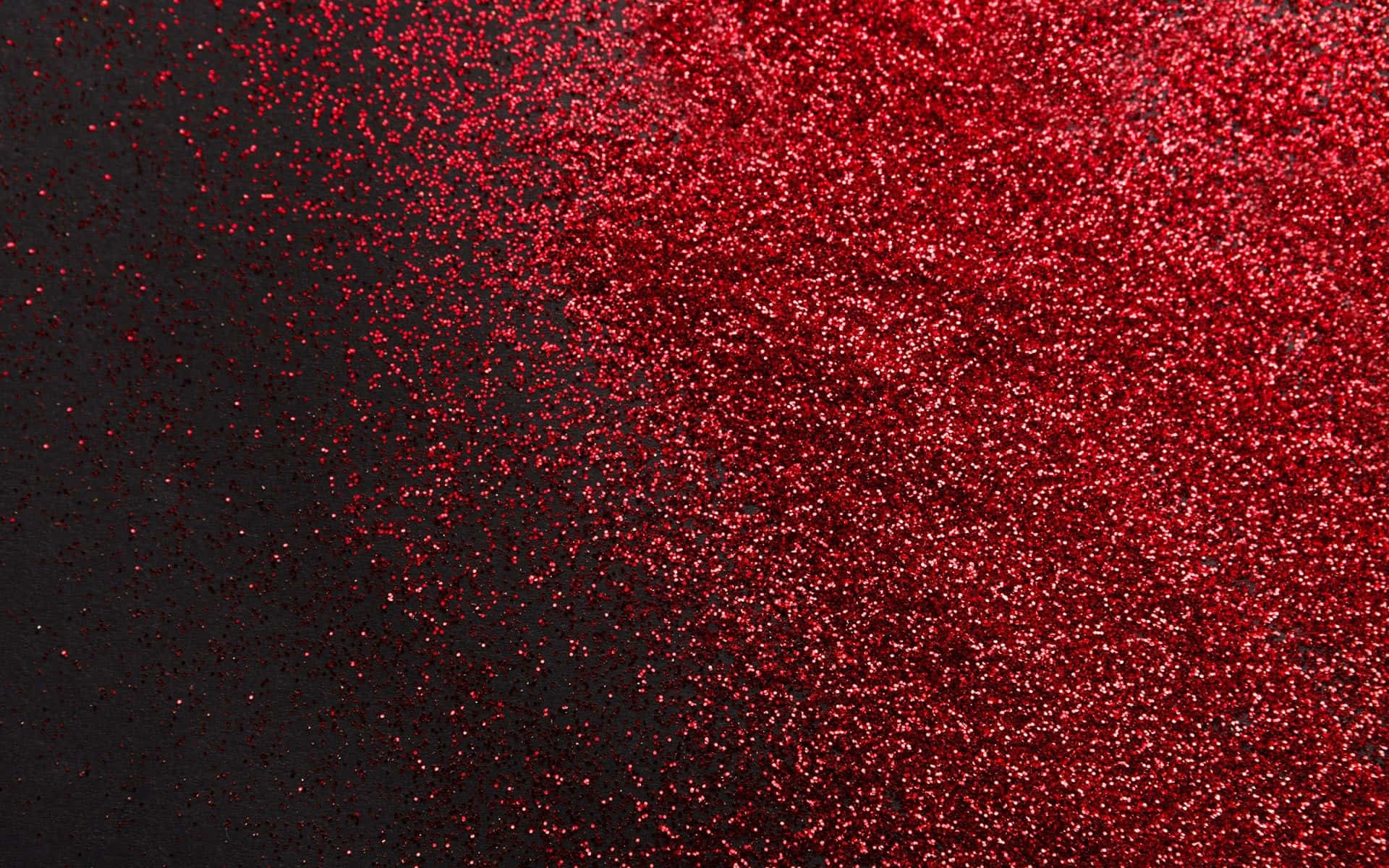 Red Cute Aesthetic 桌布 壁紙 — 充滿活力的紅色亮粉顆粒沿對角線傾瀉在深黑色背景上，營造出閃爍的紋理效果。