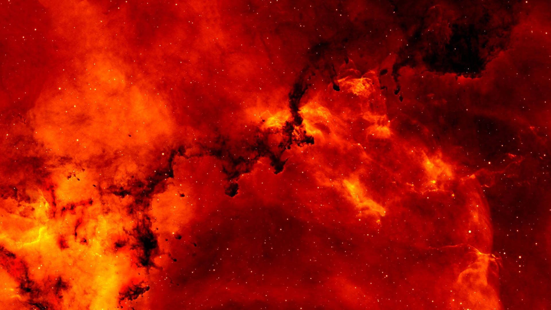 宇宙美學 桌布 壁紙 — 充滿活力的紅色和橙色宇宙星雲，帶有發光的氣體雲和散落的星星，襯托著黑暗的虛空。