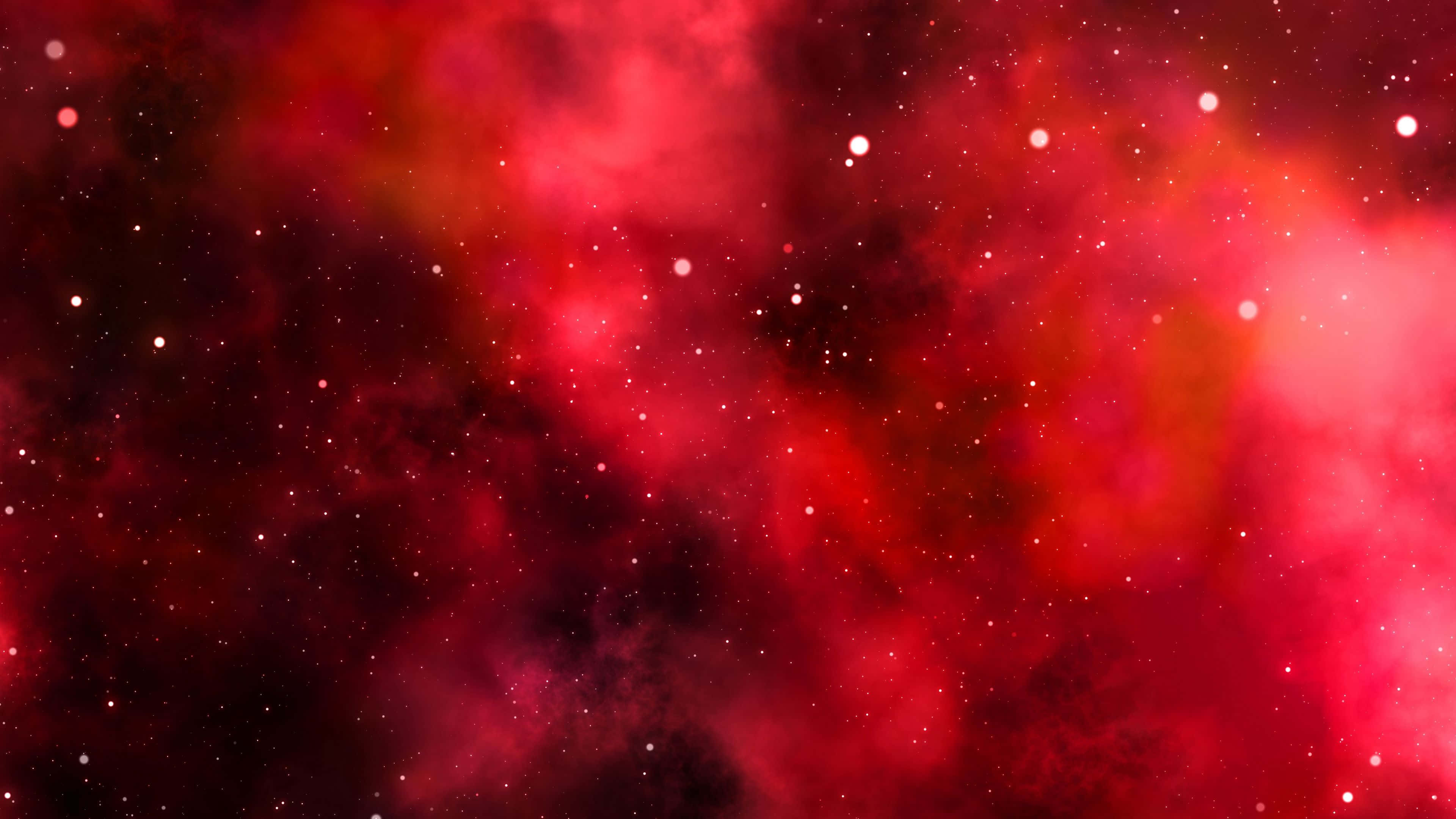 桌布 壁紙 — 充滿活力的紅色星雲雲層與發光的星星在宇宙虛空中旋轉。