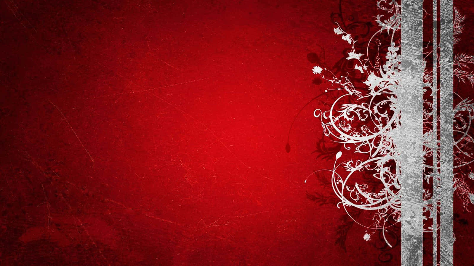 1600x900 桌布 壁紙 — 充滿活力的紅色紋理背景，帶有複雜的白色花卉漩渦和右側的垂直銀色條紋。