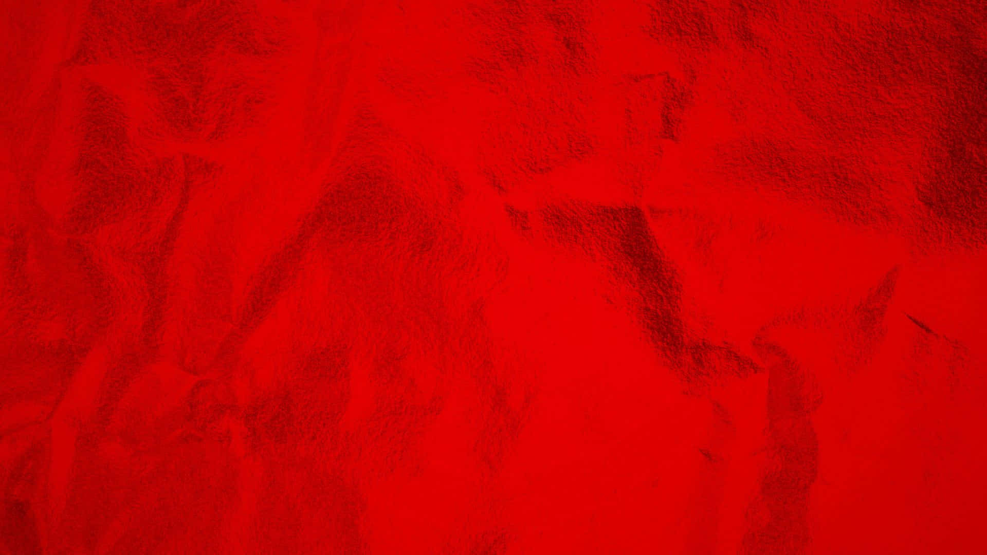 Textured 桌布 壁紙 — 充滿活力的紅色紋理表面，色調和深度有細微變化，營造出大膽的抽象視覺效果。