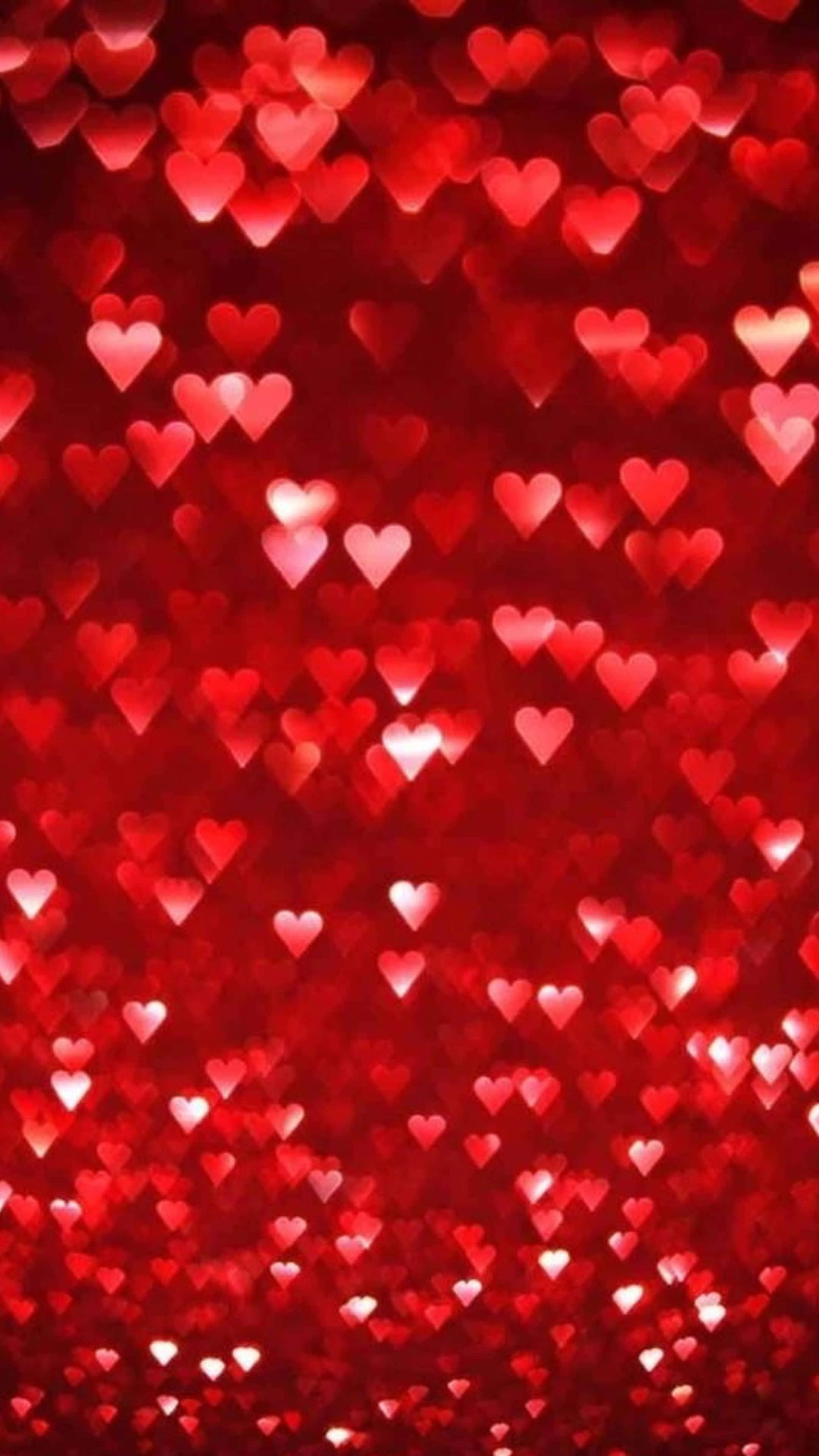 Red Hearts 桌布 壁紙 — 充滿活力的紅色背景，佈滿發光的愛心形狀散景燈光，營造浪漫夢幻的氛圍。