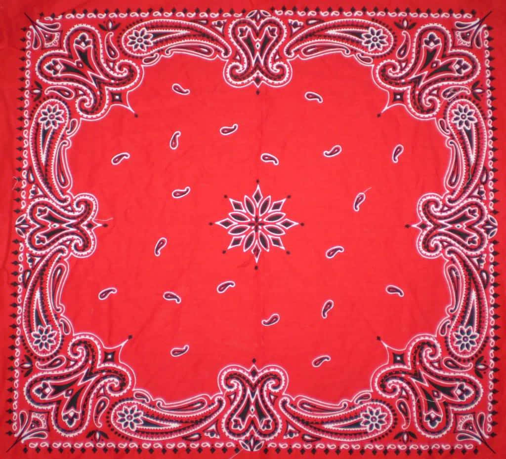 bandana 桌布 壁紙 — 充滿活力的紅色頭巾，帶有複雜的白色和黑色佩斯利邊框和中央星爆圖案。