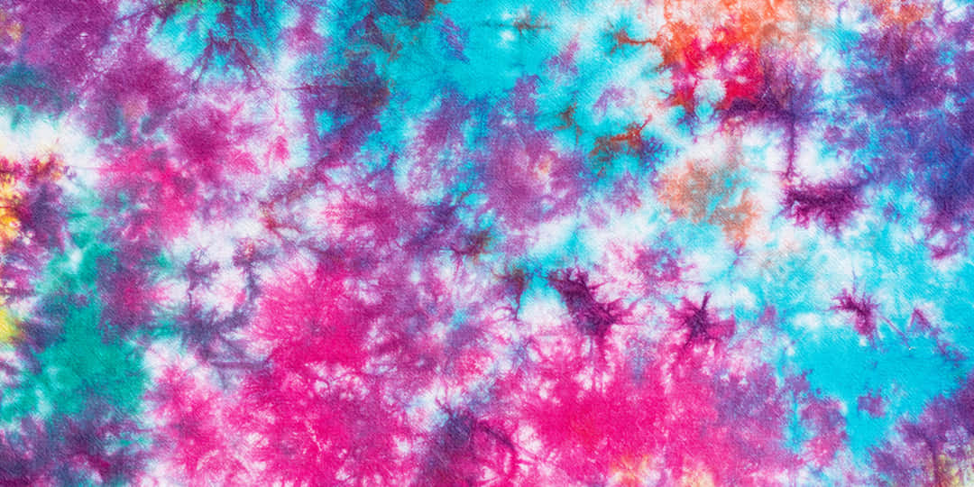 Pink Tie Dye 桌布 壁紙 — 充滿活力的紮染布料漩渦，呈現電光粉紅、藍綠色和紫色，以白色為底色。