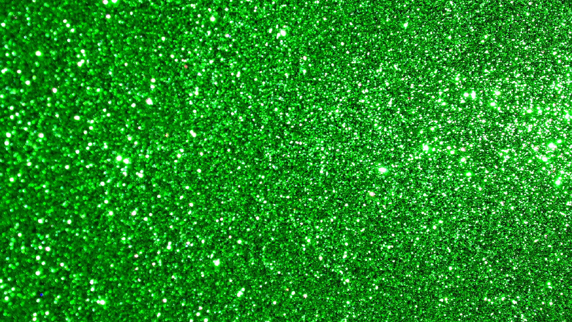 Green Glitter 桌布 壁紙 — 充滿活力的綠色亮粉密集地散佈在整個畫面上，營造出耀眼的有紋理表面。