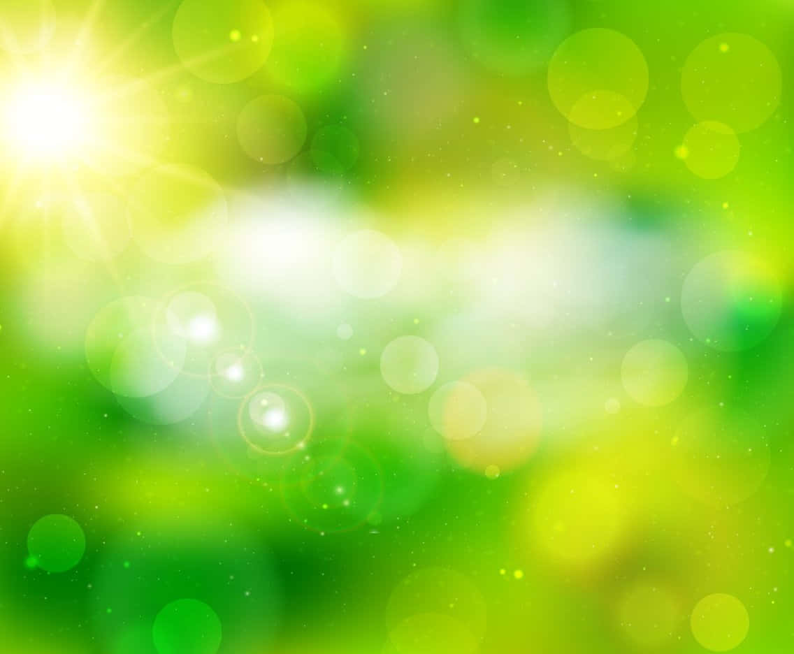Abstract Green 桌布 壁紙 — 充滿活力的綠色和黃色散景燈光，在柔和模糊的自然環境中帶有明亮的太陽爆發光芒。